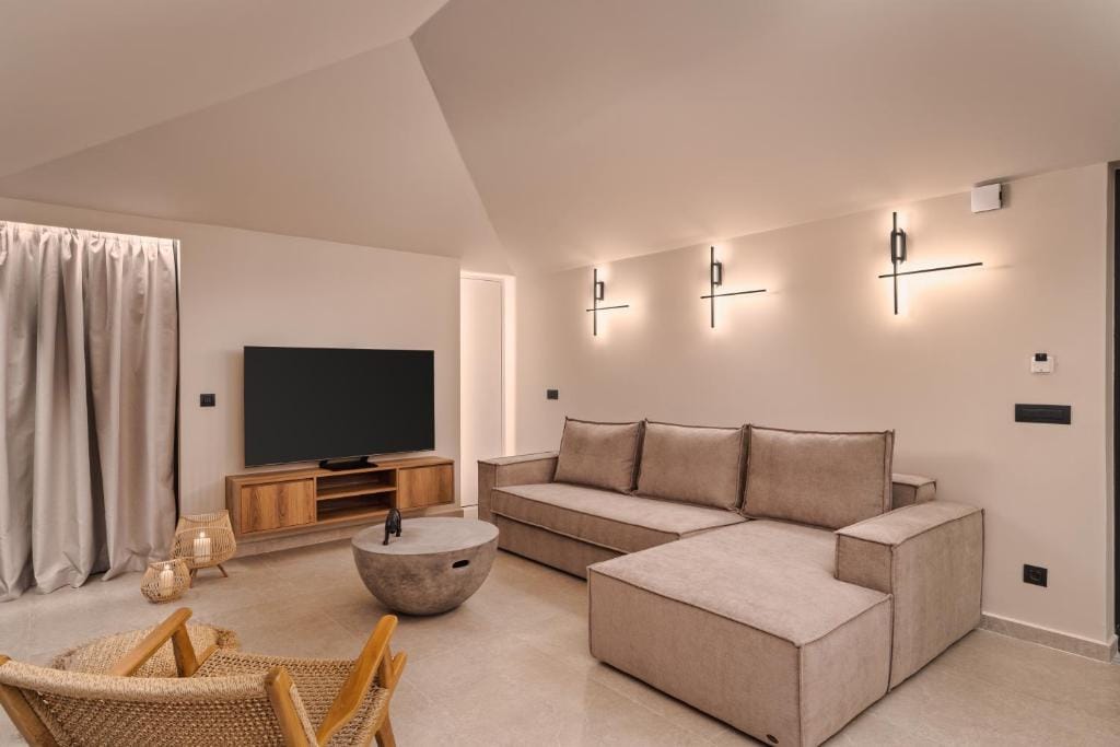 a living room with a tv and couches