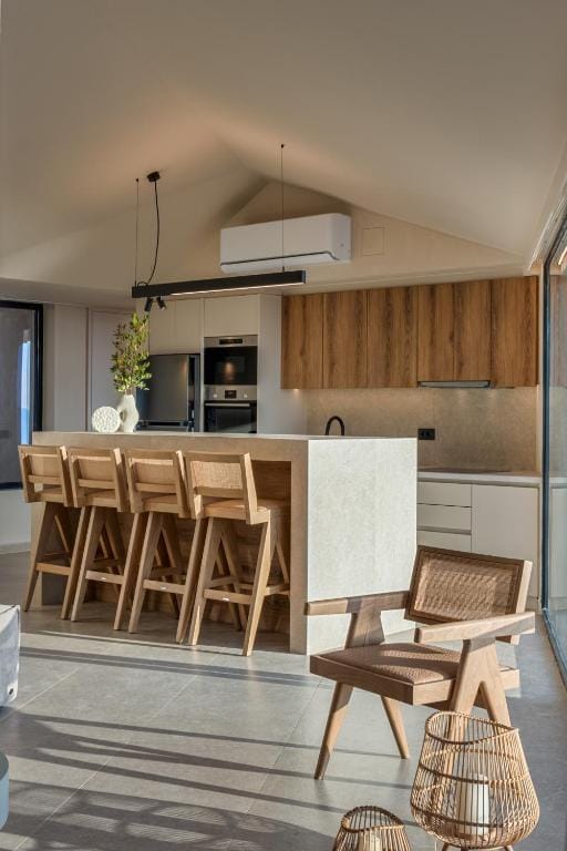 a kitchen with a table and chairs