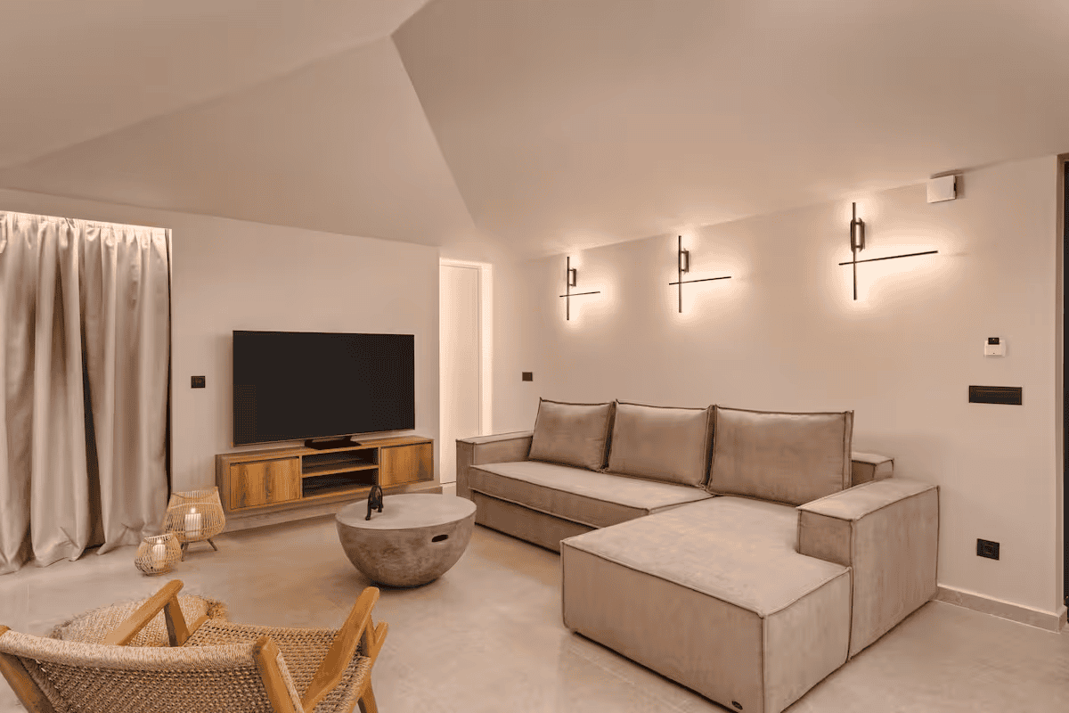 a living room with a tv and couches