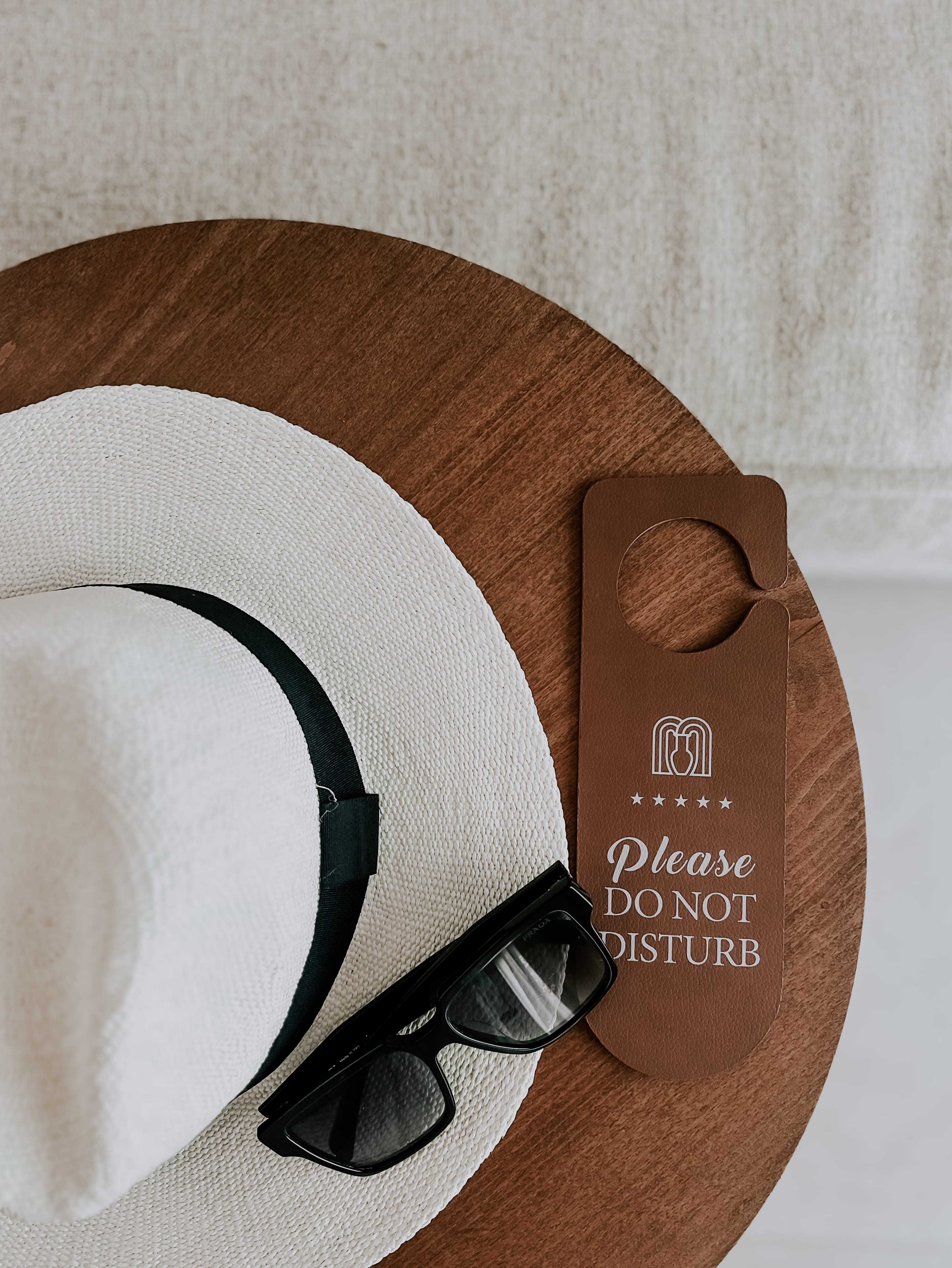 a pair of sunglasses on a person's wrist