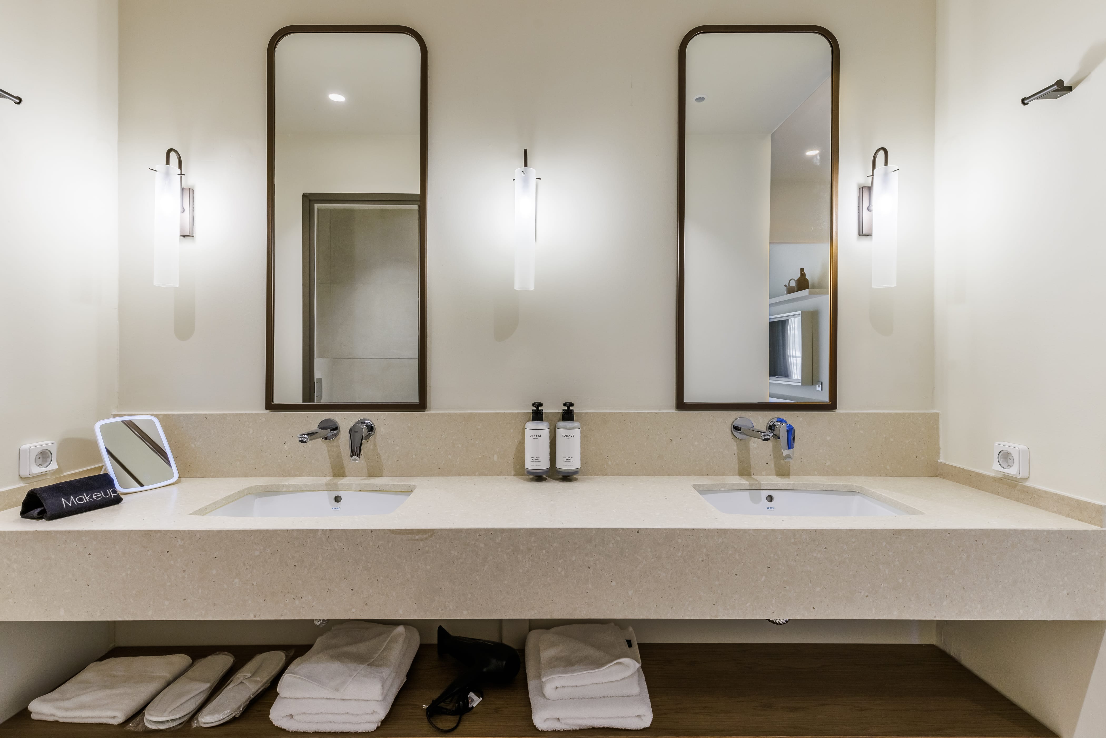 a bathroom with two mirrors