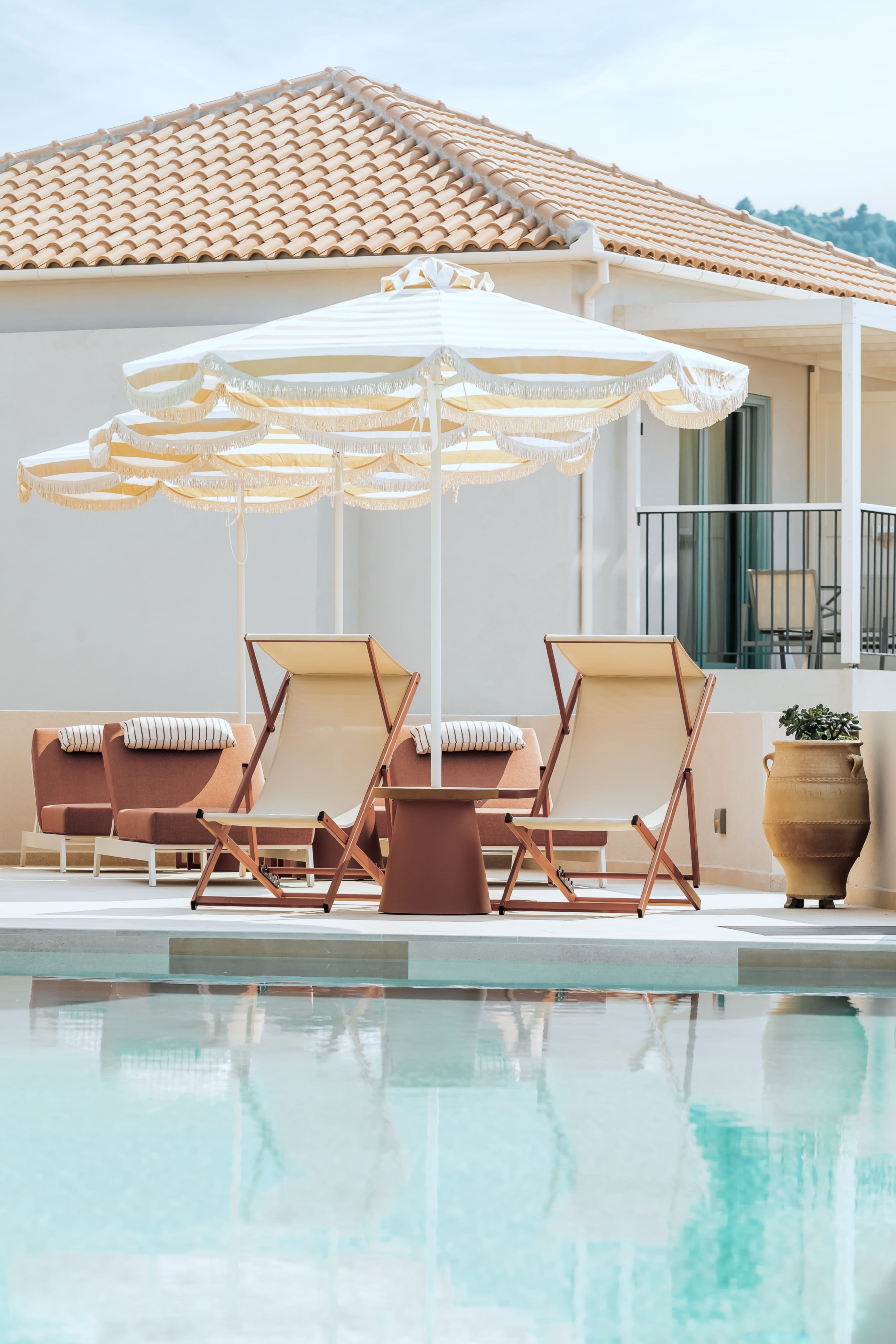 a pool with chairs and umbrellas