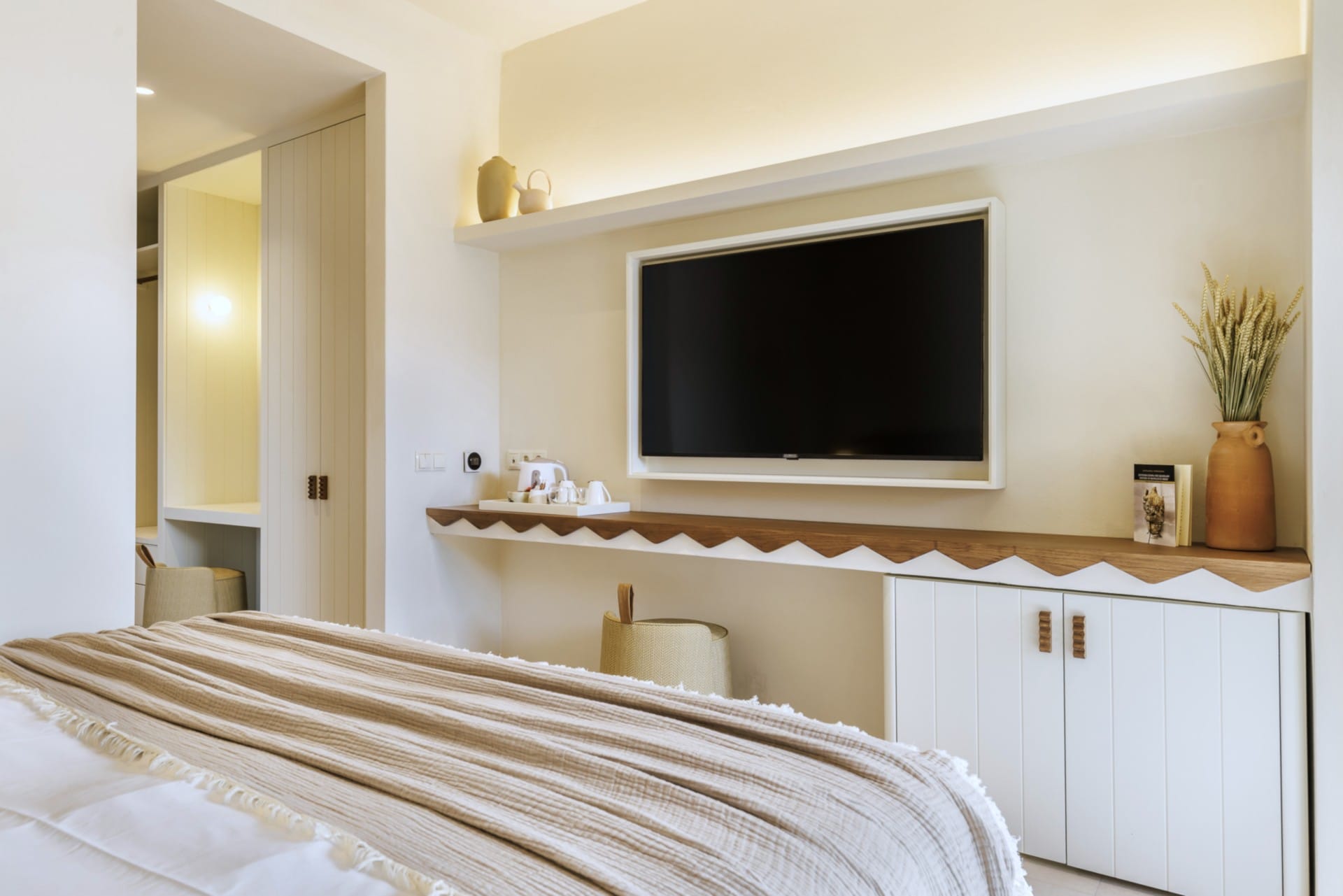 a room with a tv and a bed