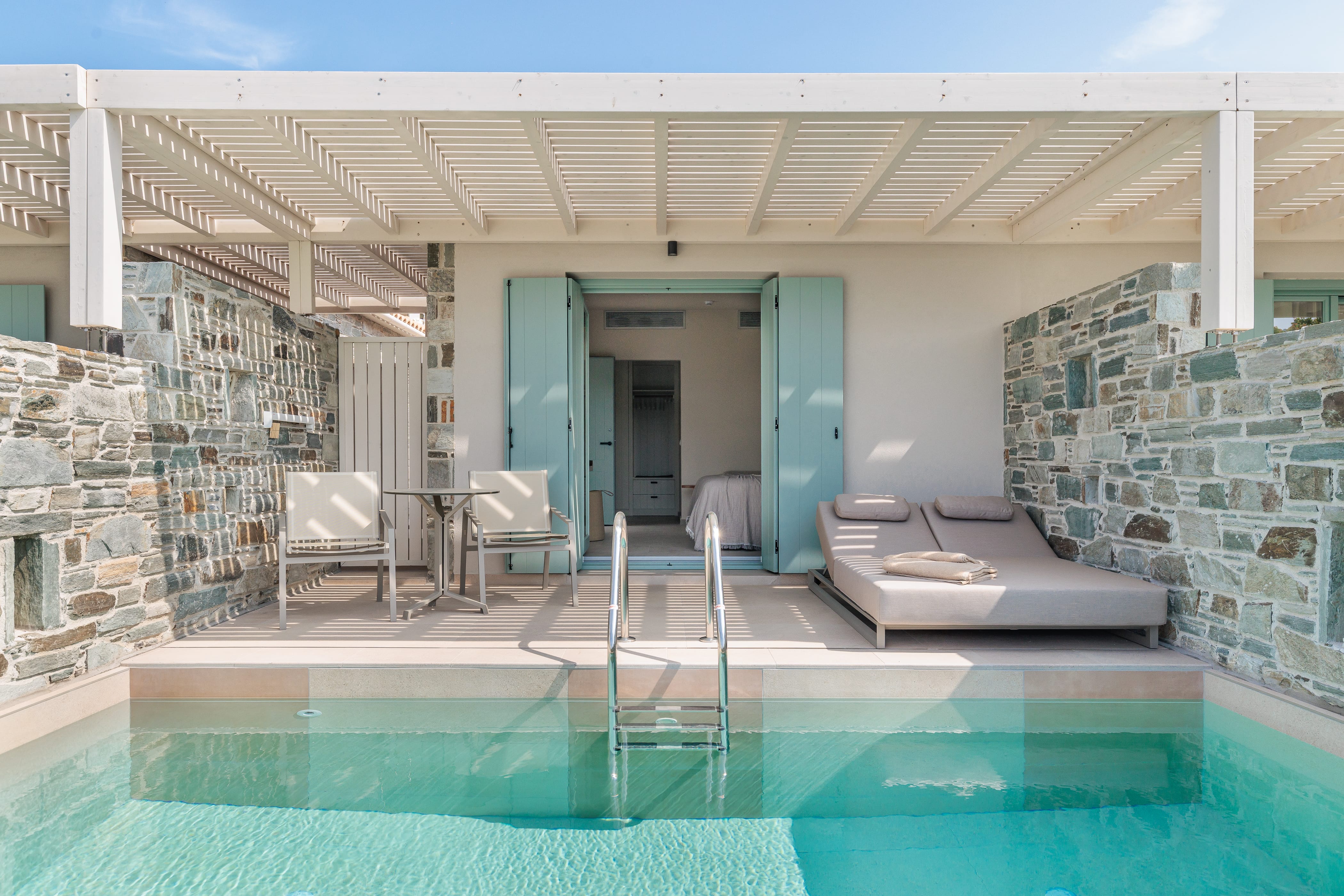a swimming pool with a couch and chairs
