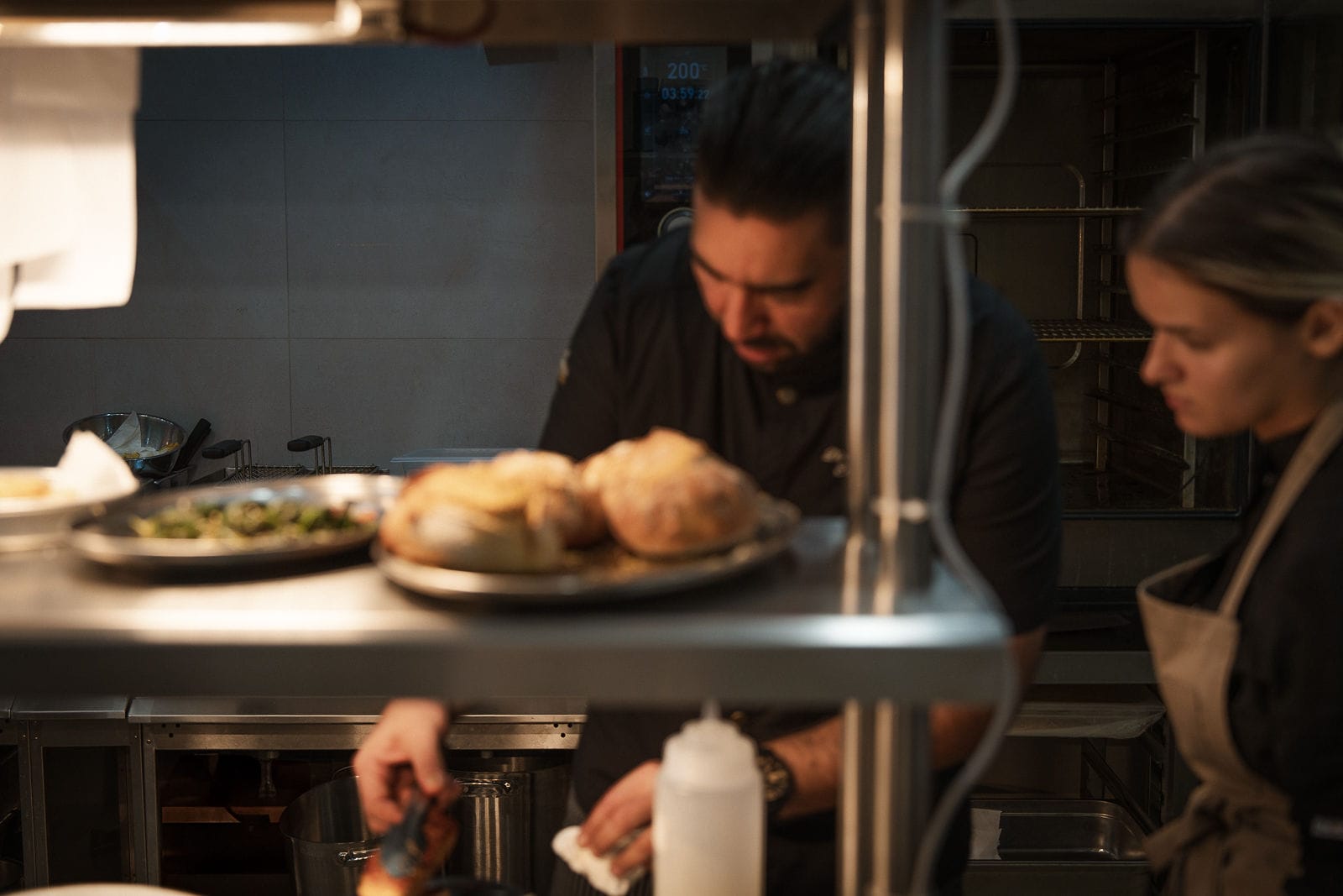 a man and a woman cooking food