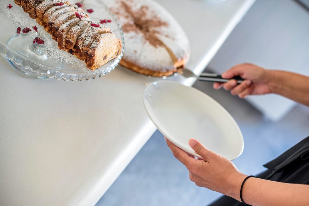 a person cutting a cake