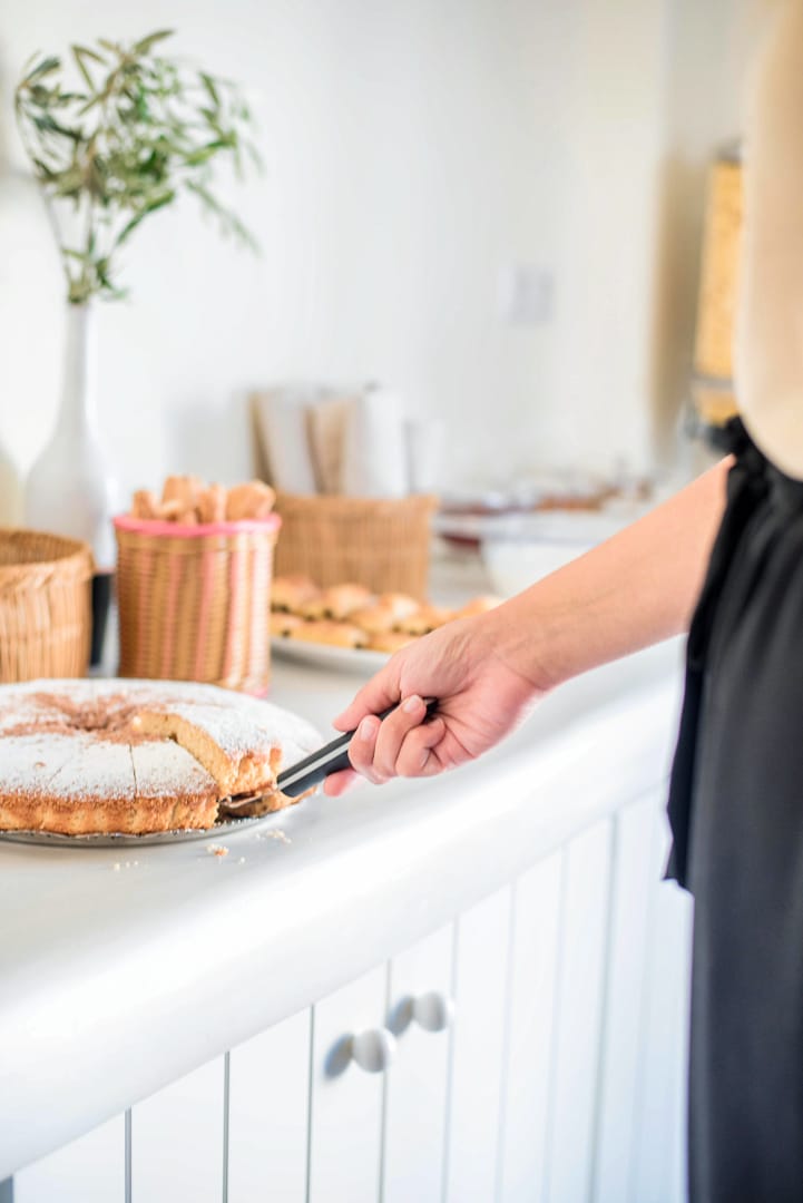 a person cutting a cake