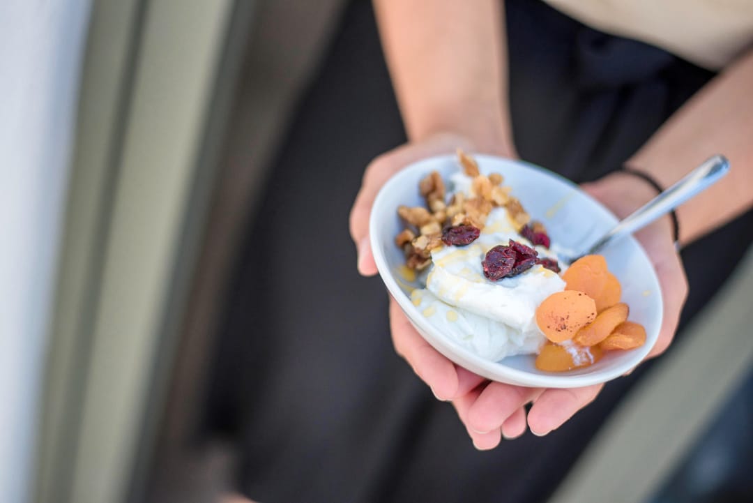 a person eating a bowl of fruit