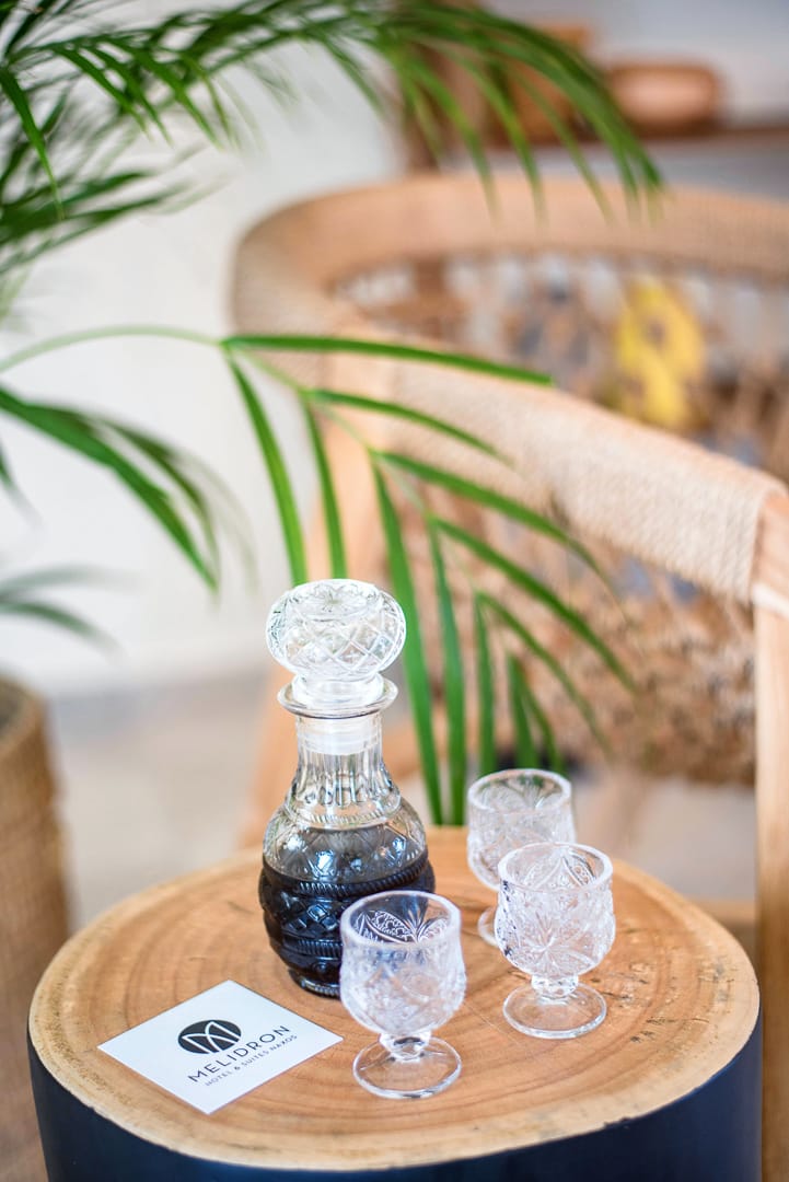 a bottle of liquor and glasses on a table
