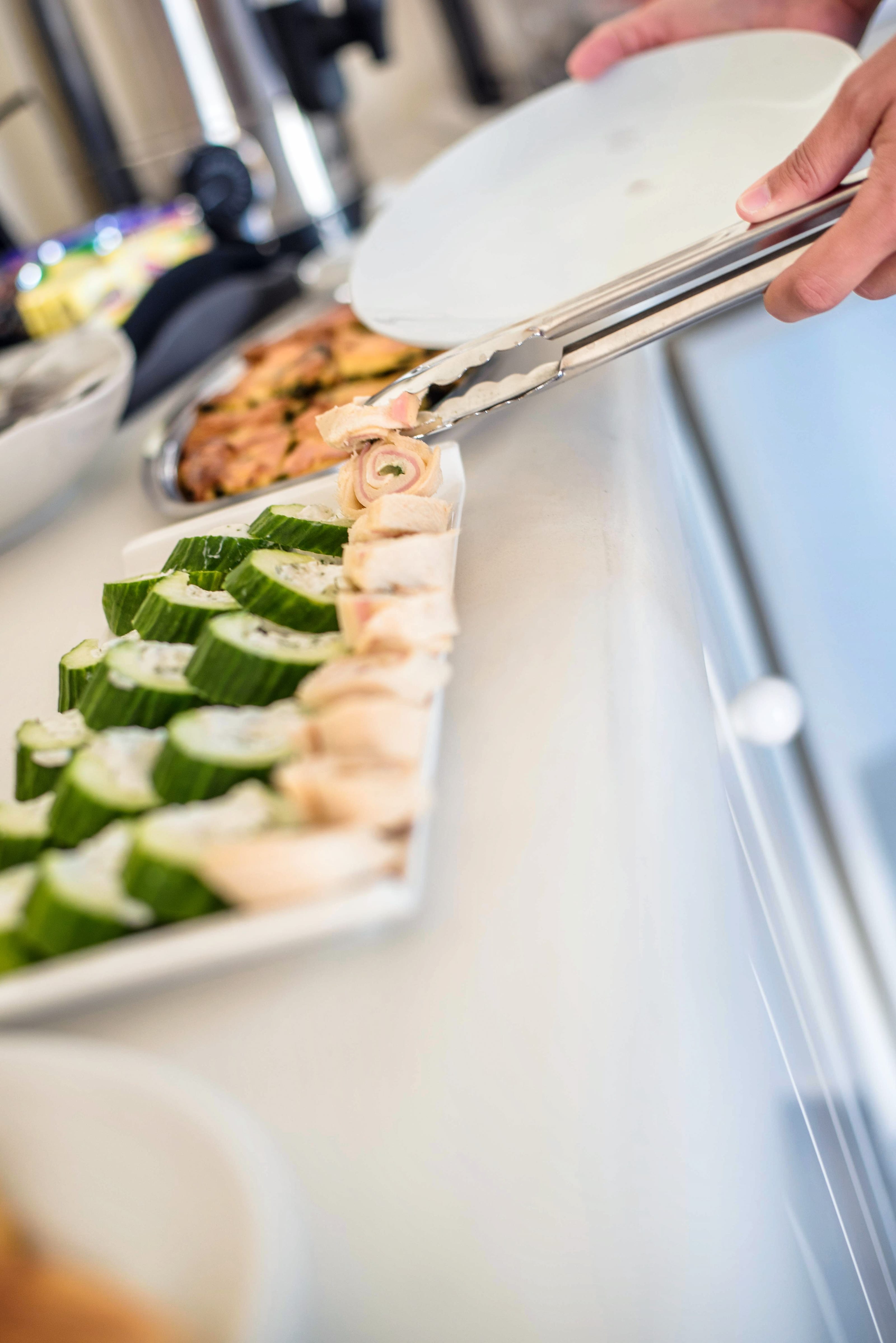 a person cutting a pizza