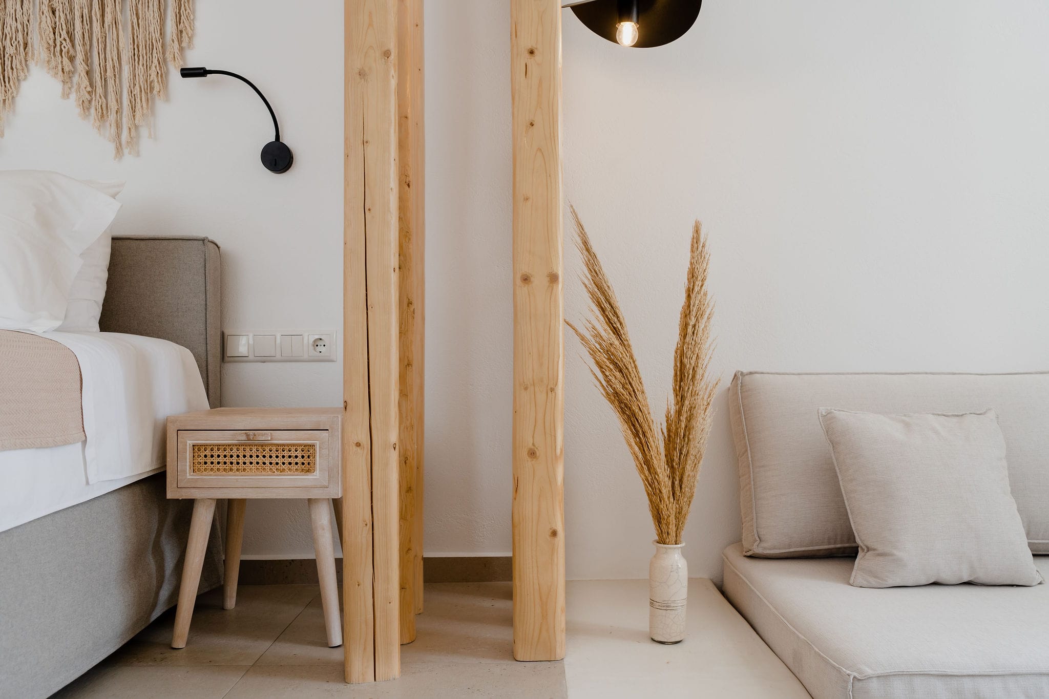 a room with white couches and a wood chair