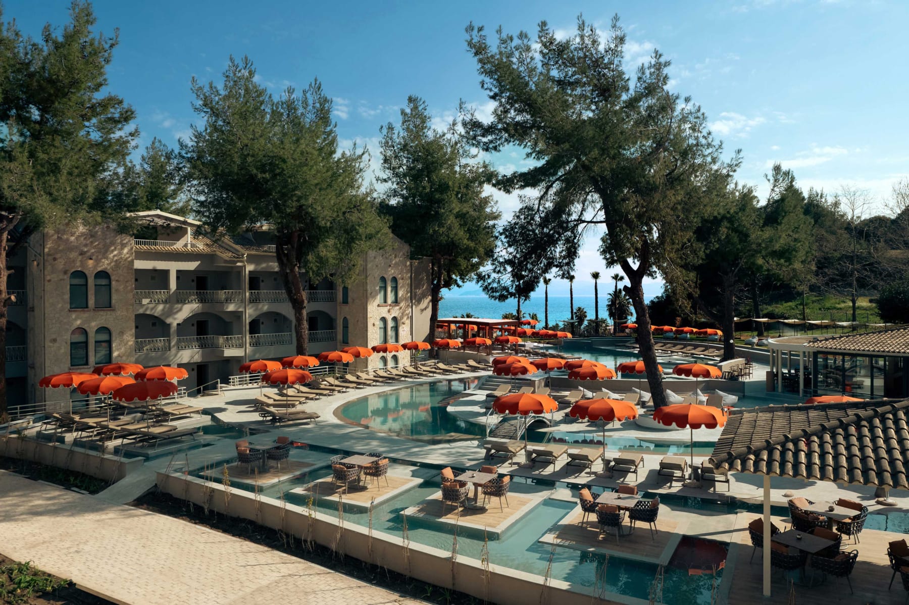 a pool with umbrellas and chairs