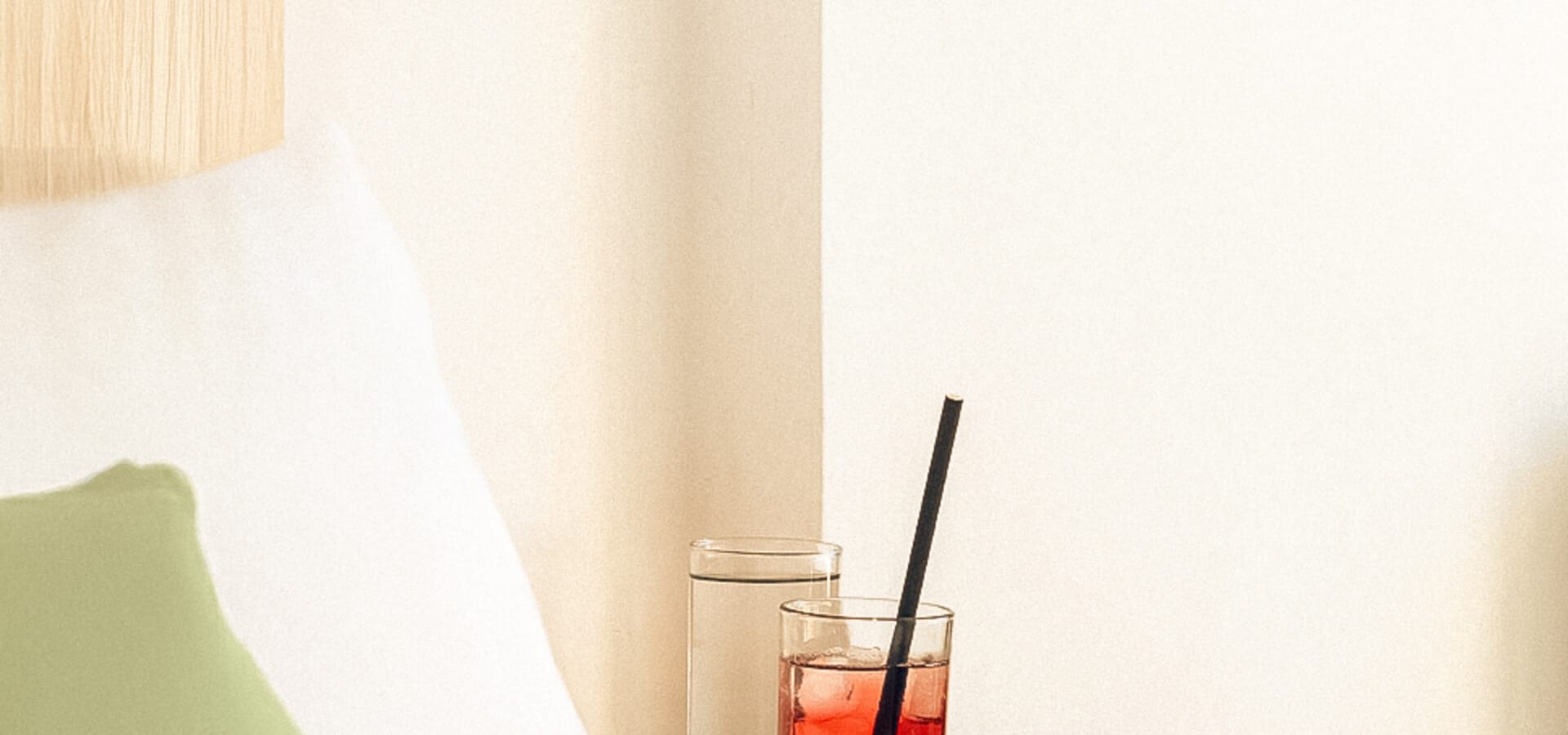 a glass of red liquid on a table