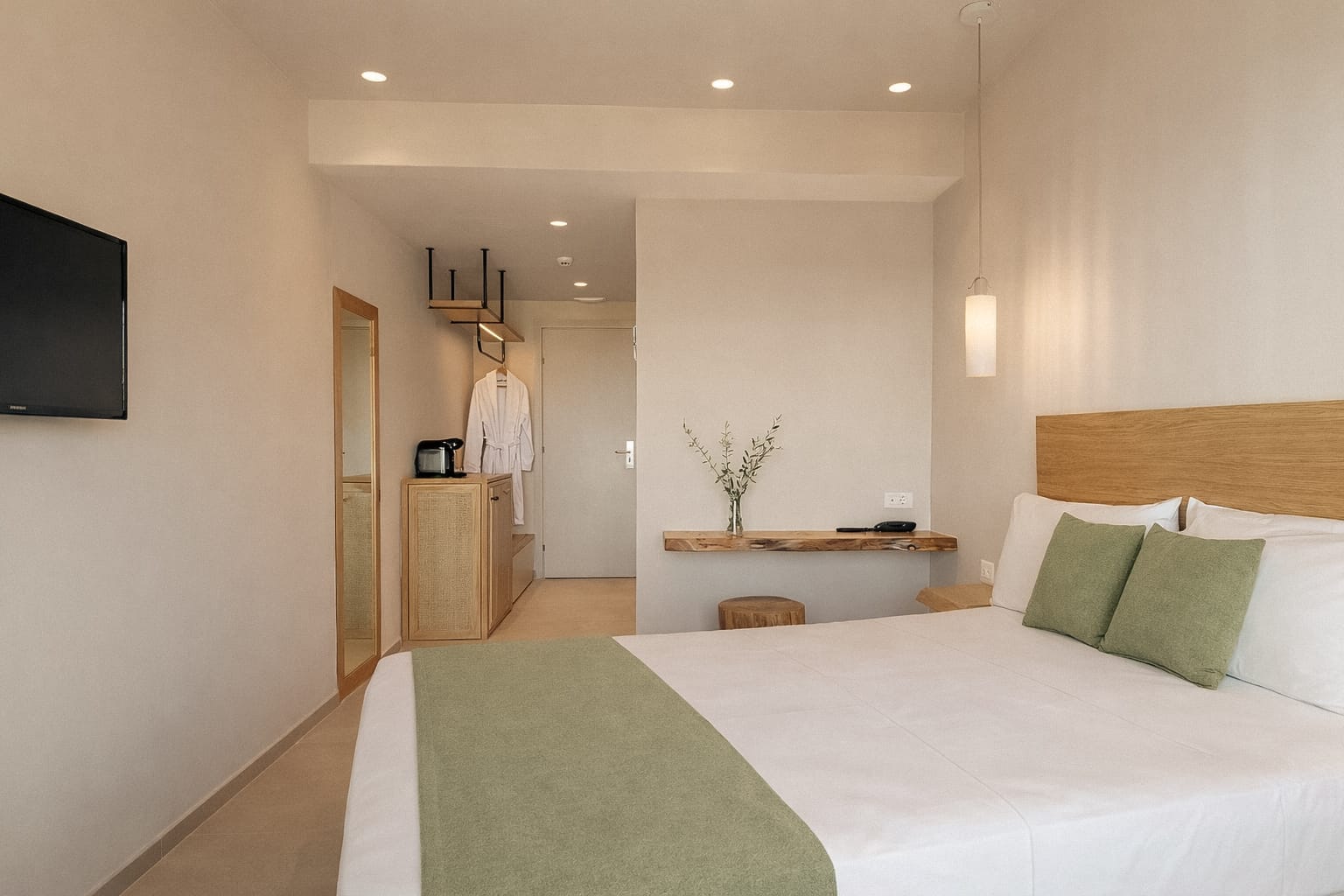 a hotel room with a bed and a tv