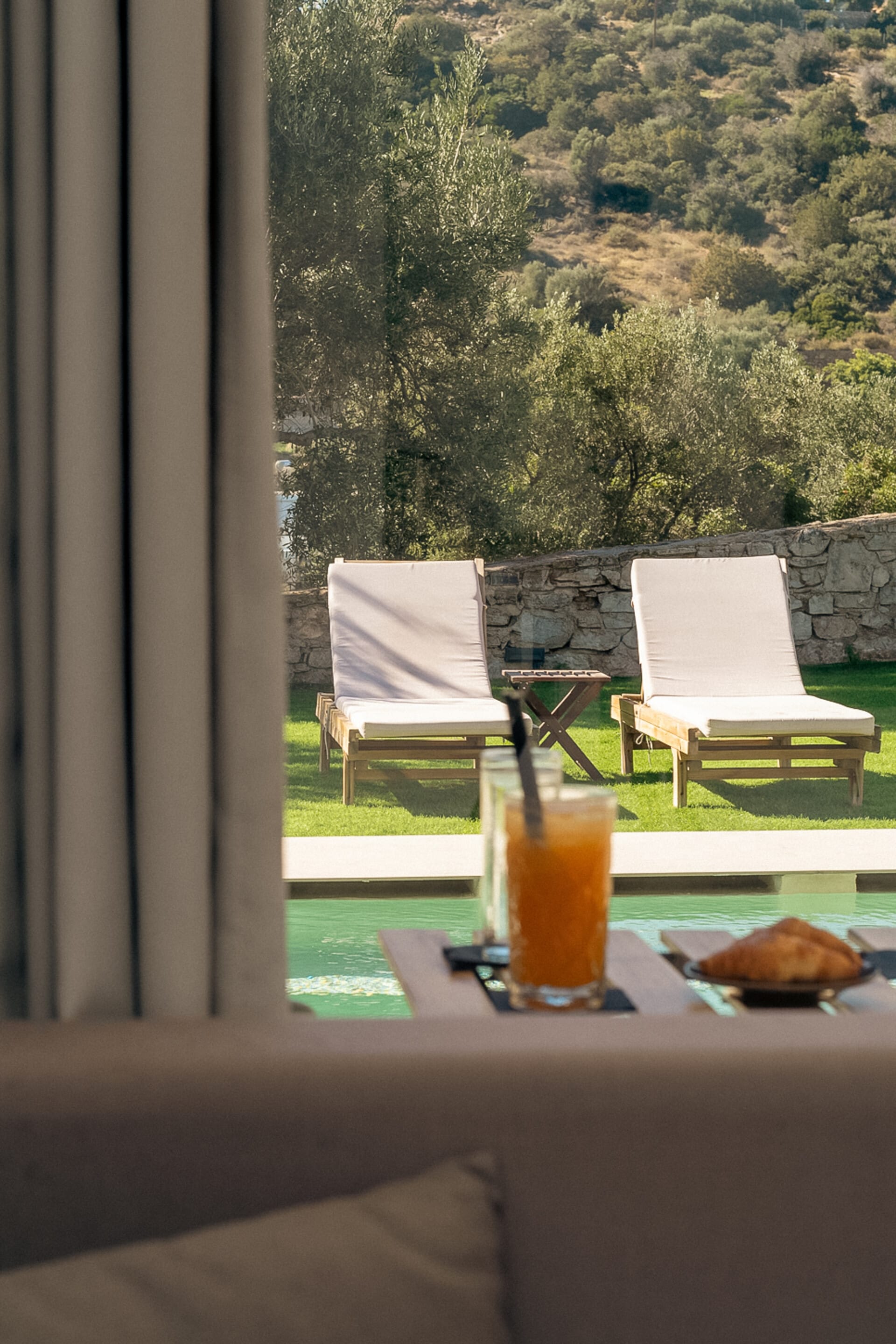 a glass of orange juice on a table with a glass of orange juice