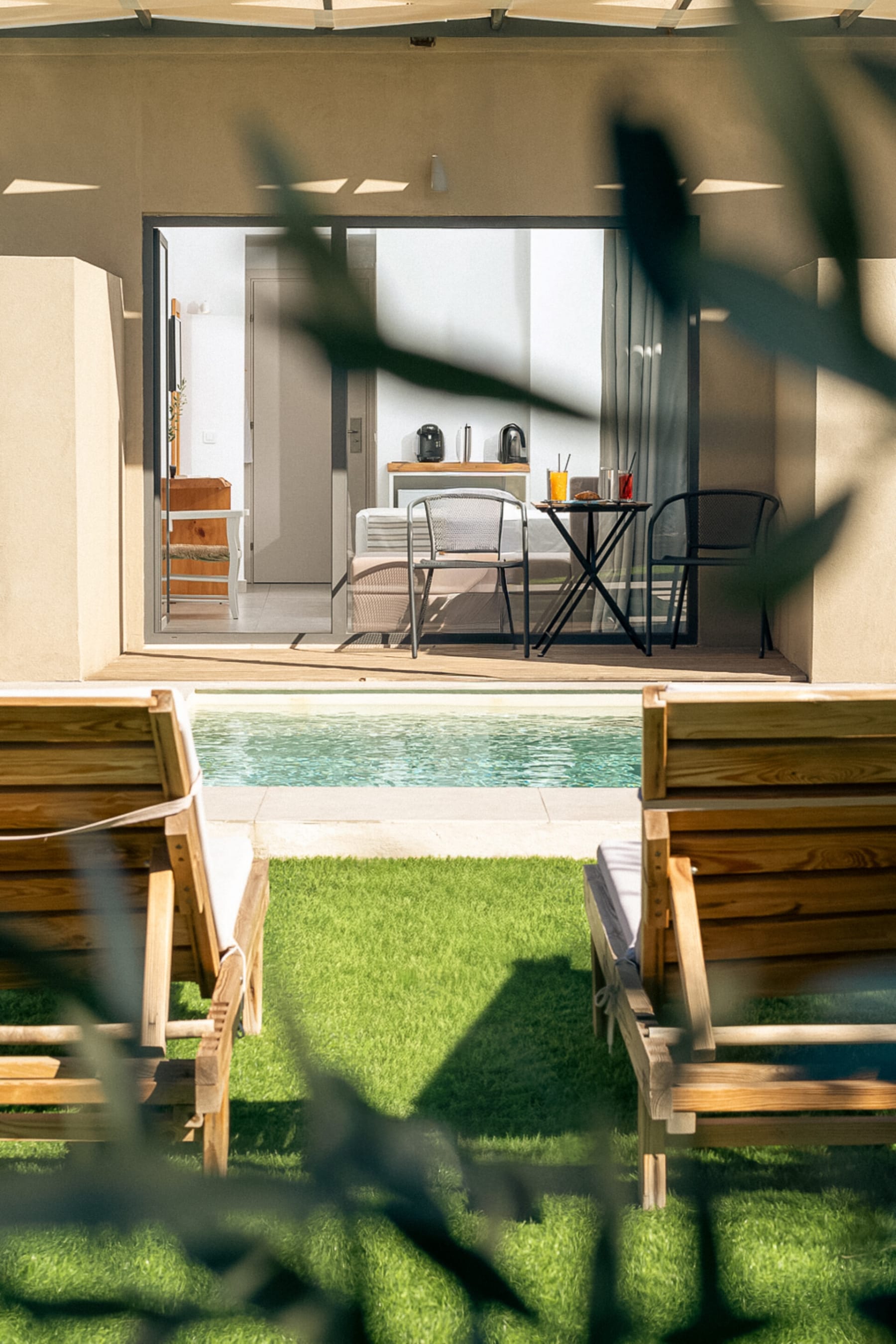 a room with a table chairs and a pool