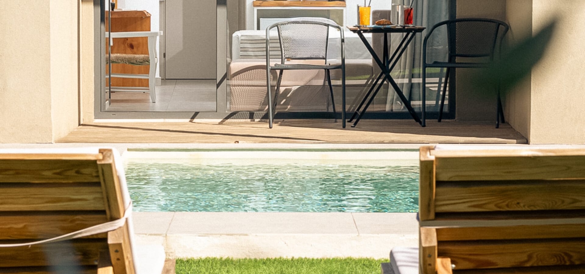 a room with a table chairs and a pool