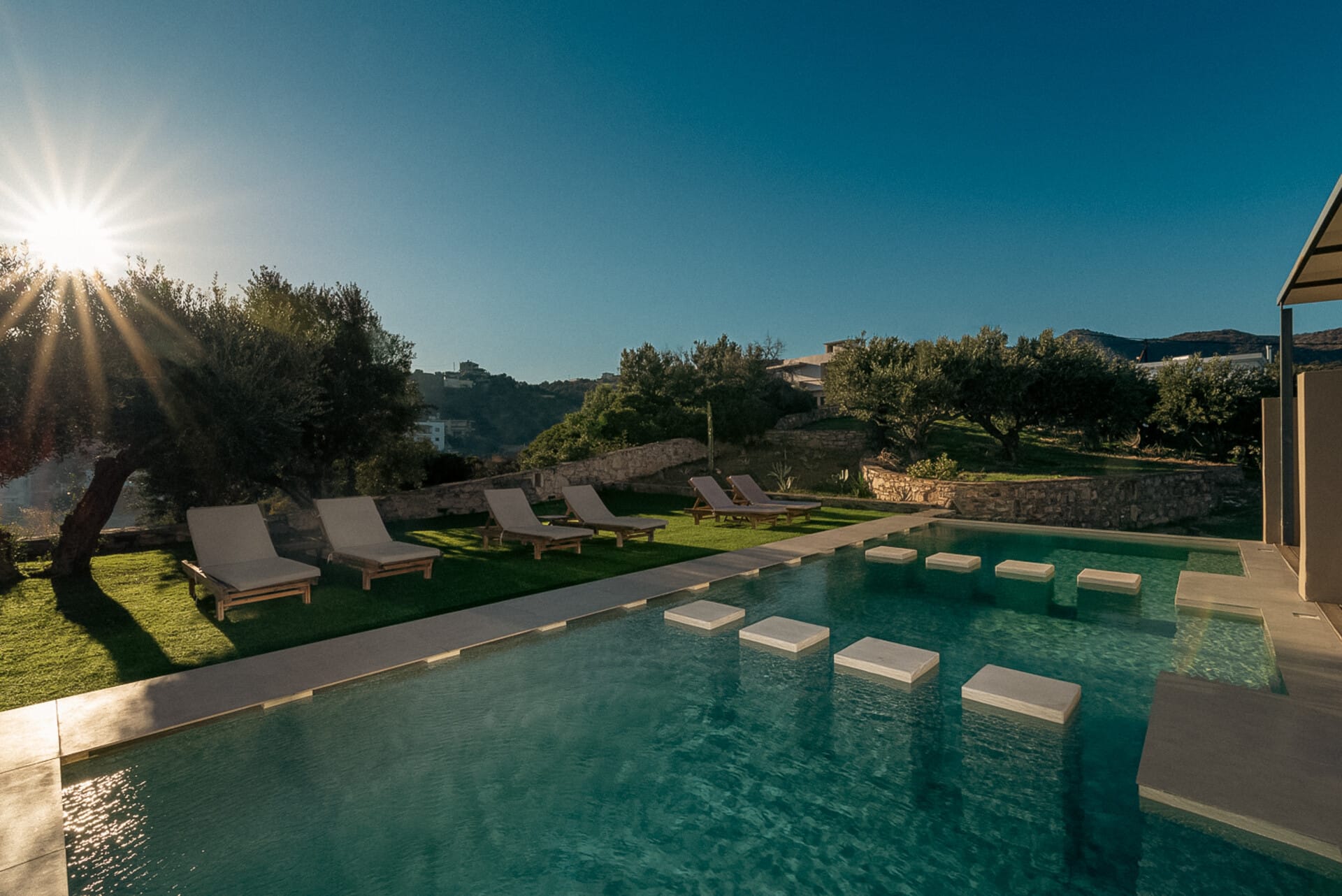 a swimming pool with chairs around it