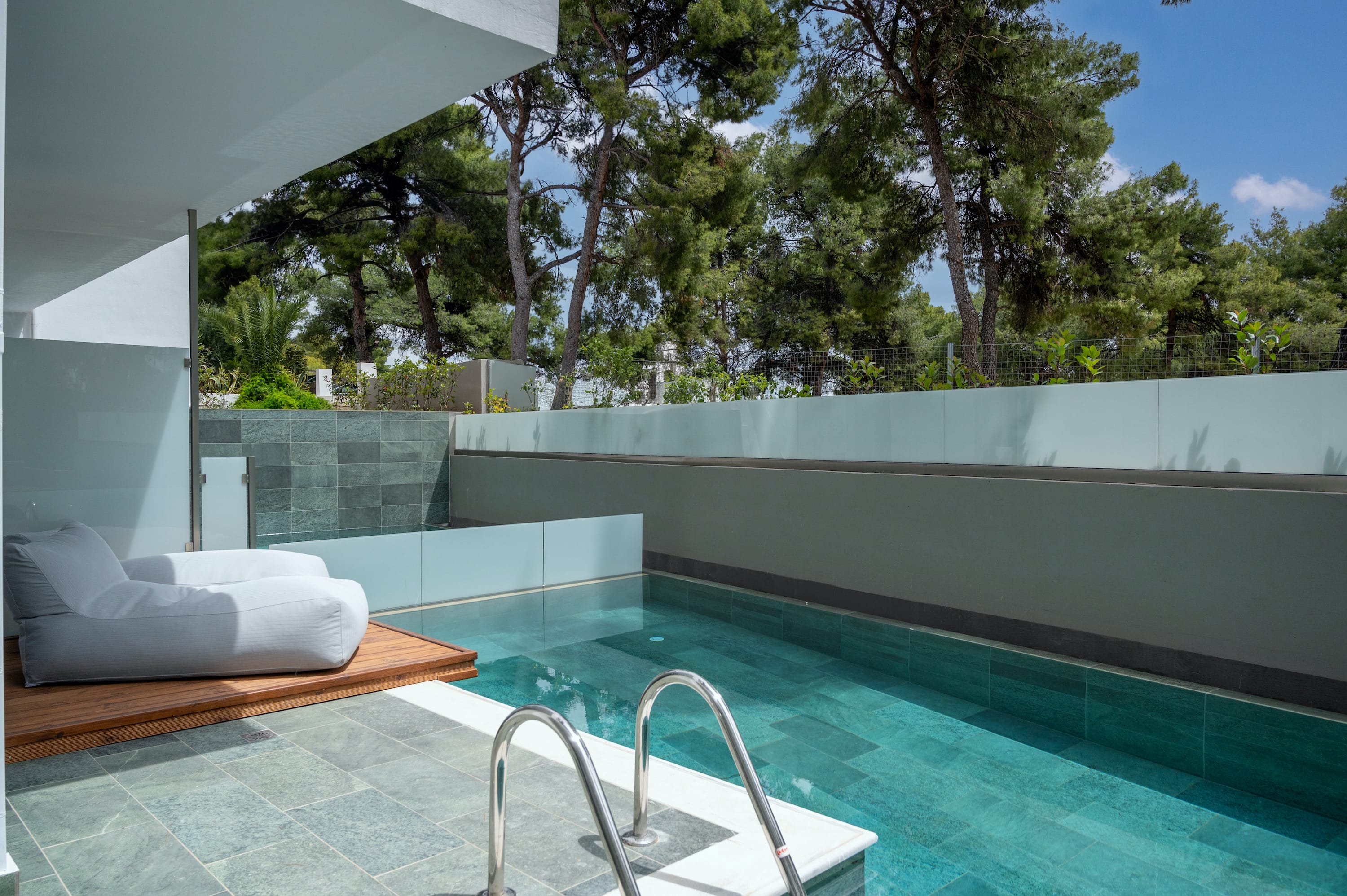 a pool with a deck and trees