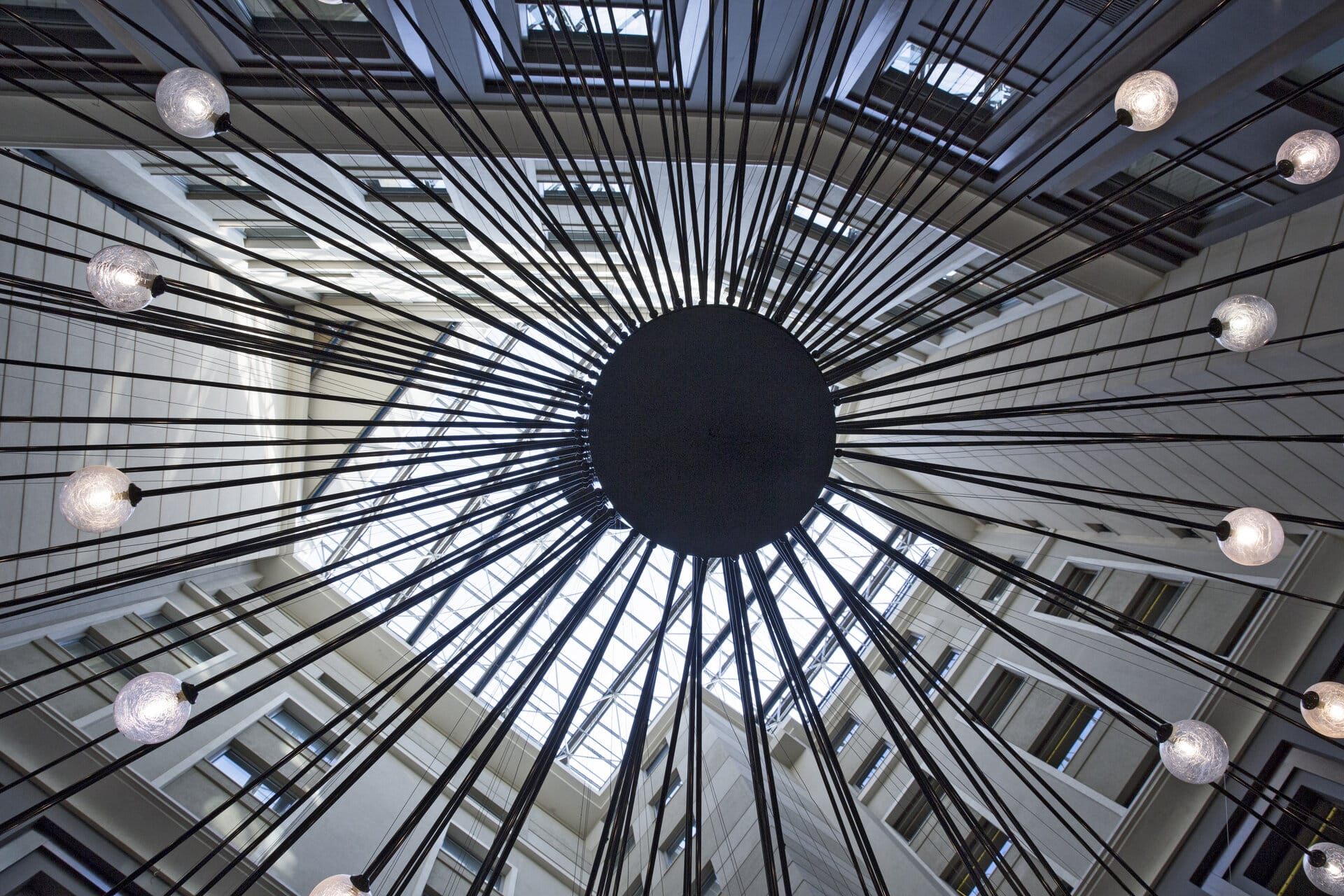 a large glass ceiling with a round black object in the center