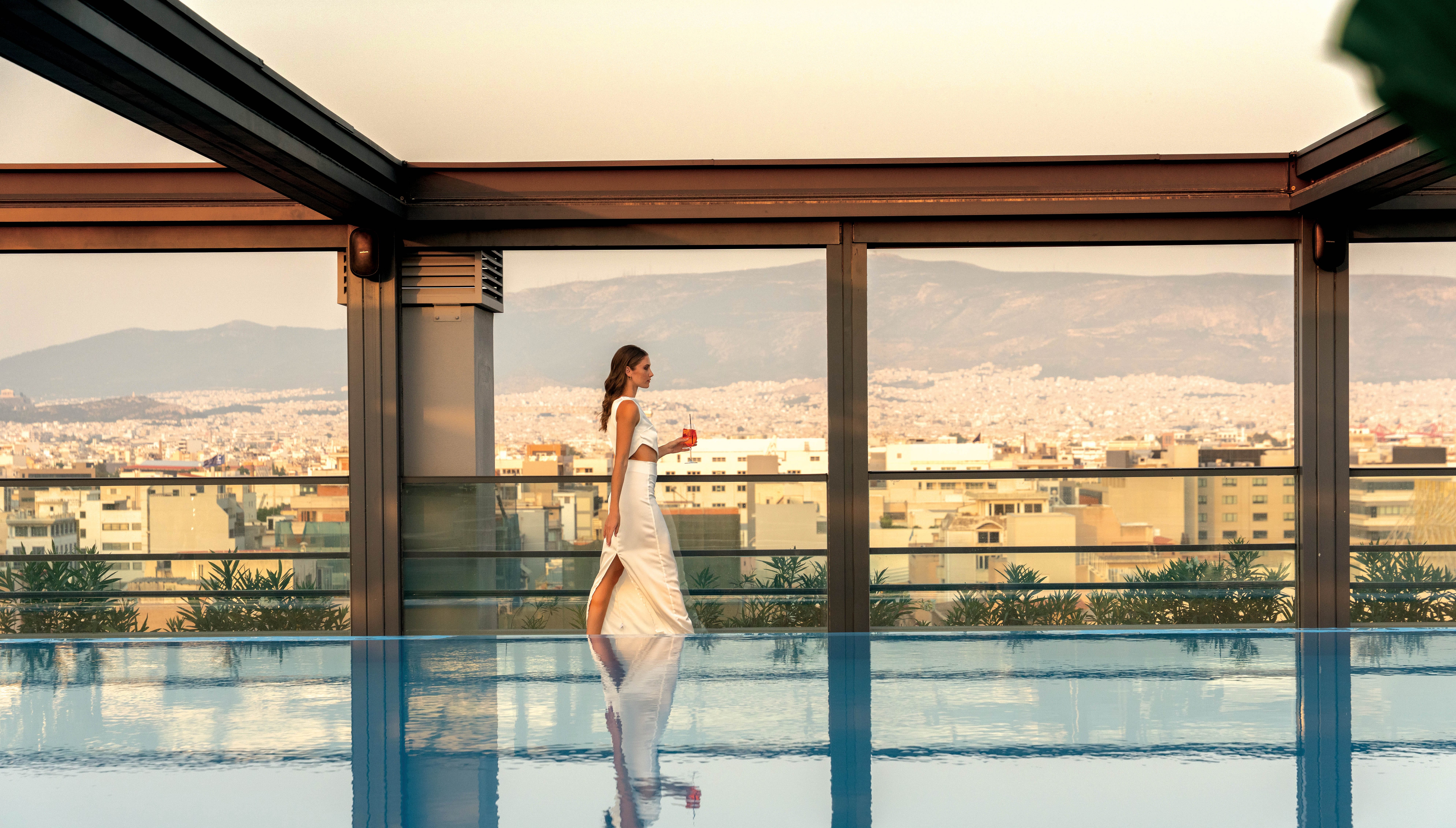 a person in a white dress walking on a glass floor