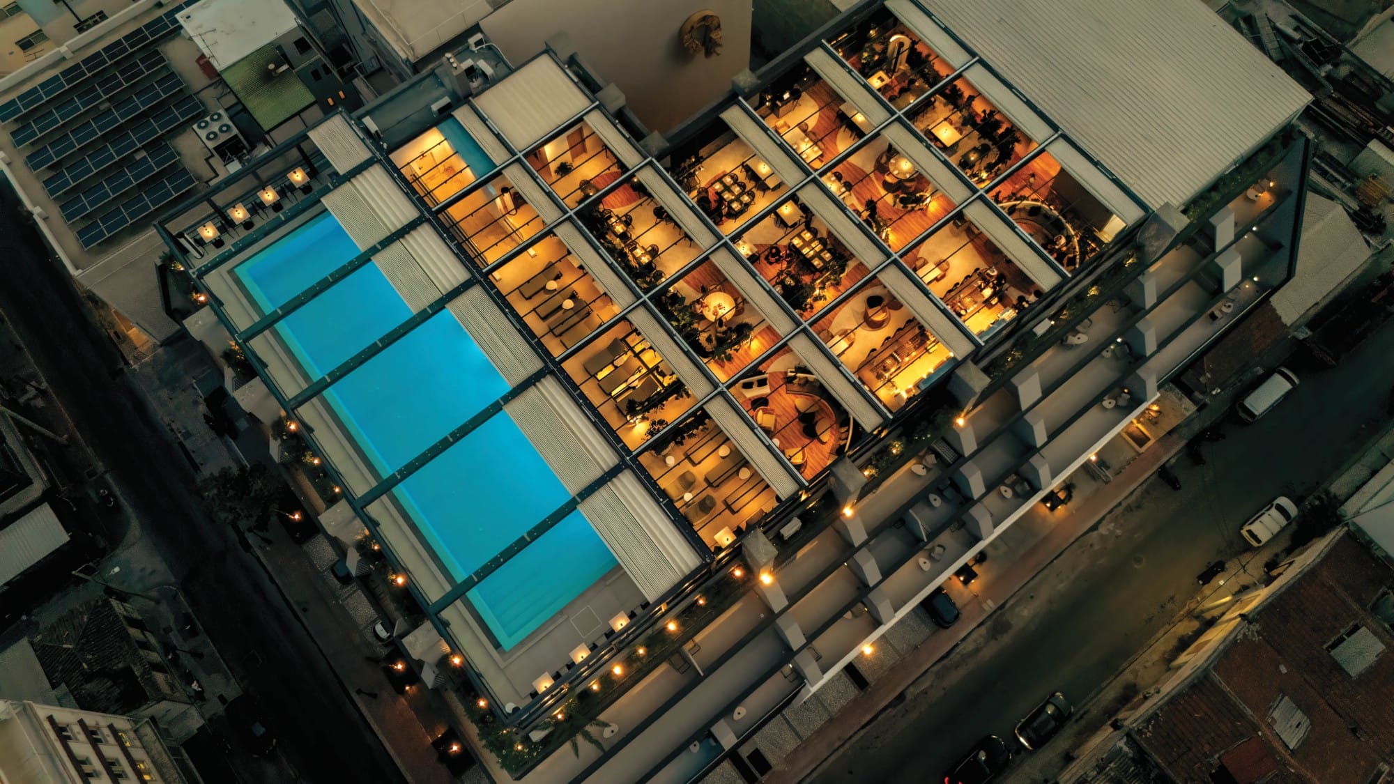 an aerial view of a building with a pool