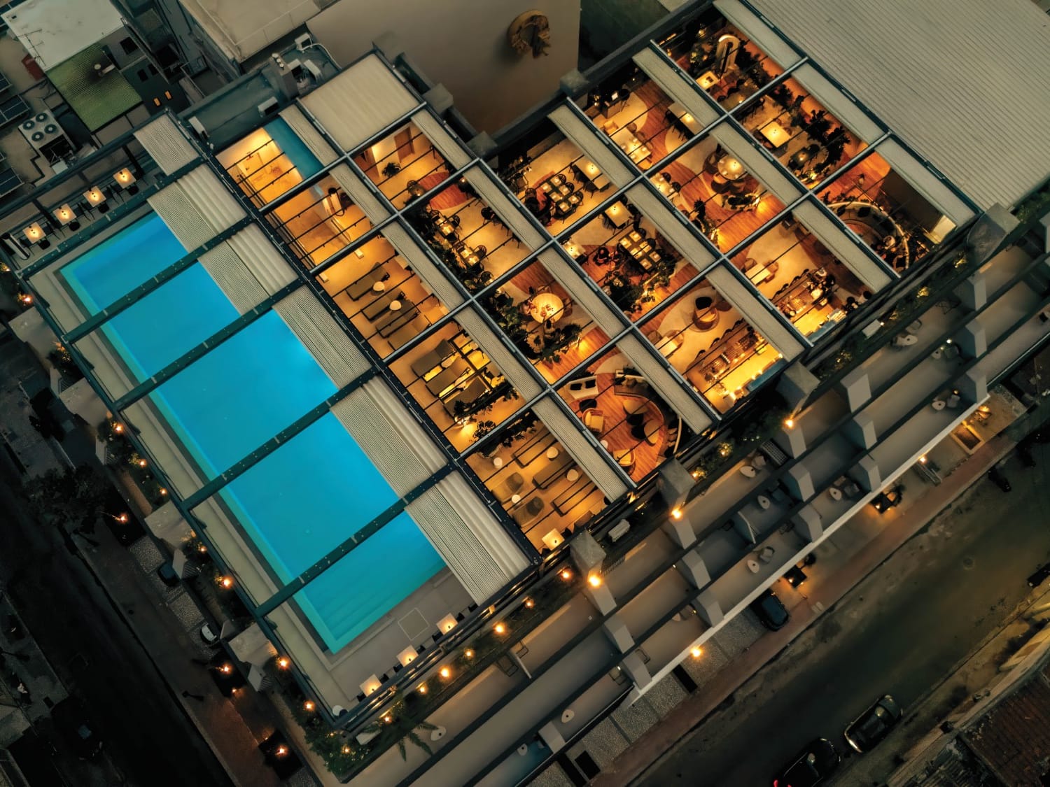 an aerial view of a building with a pool
