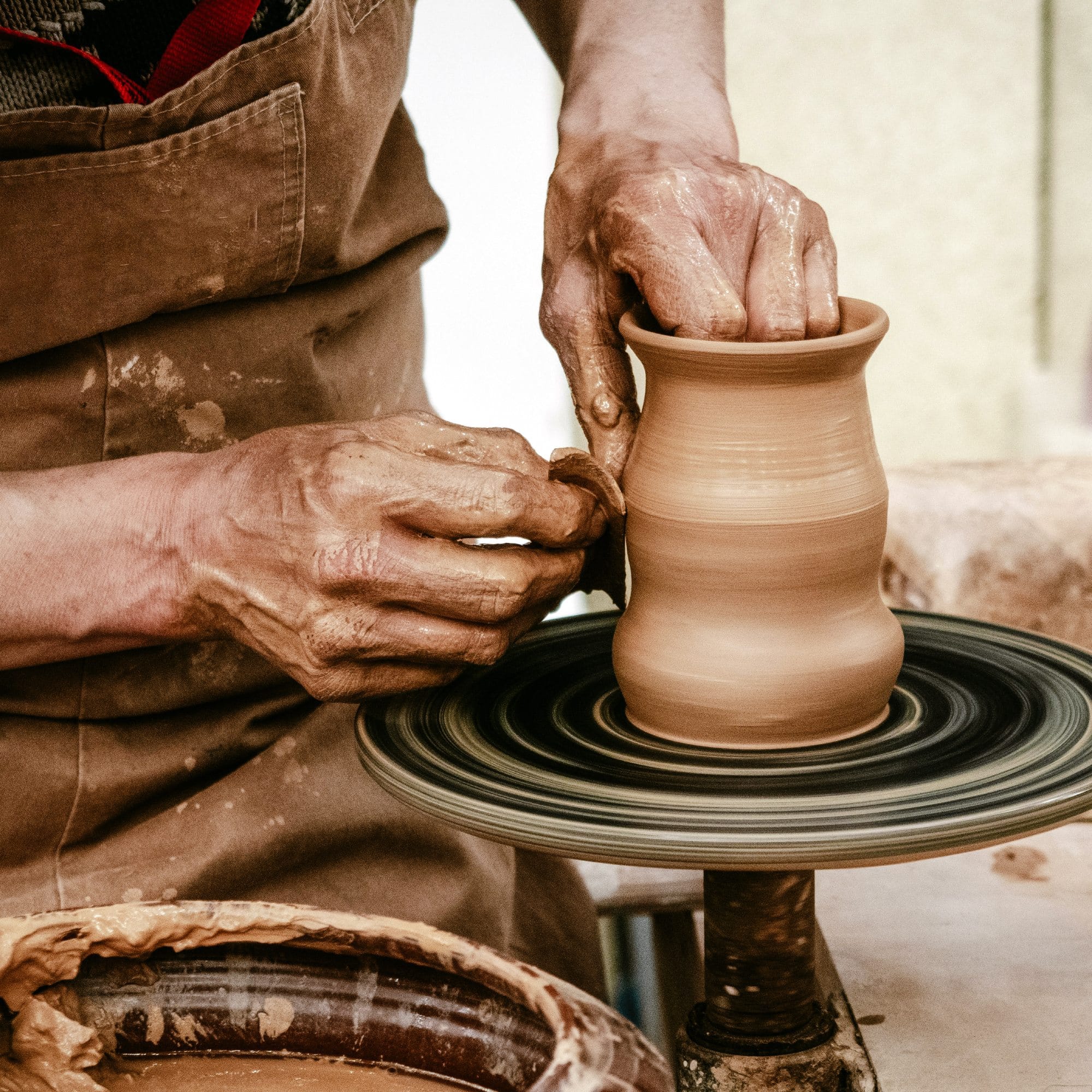 a person is making a vase