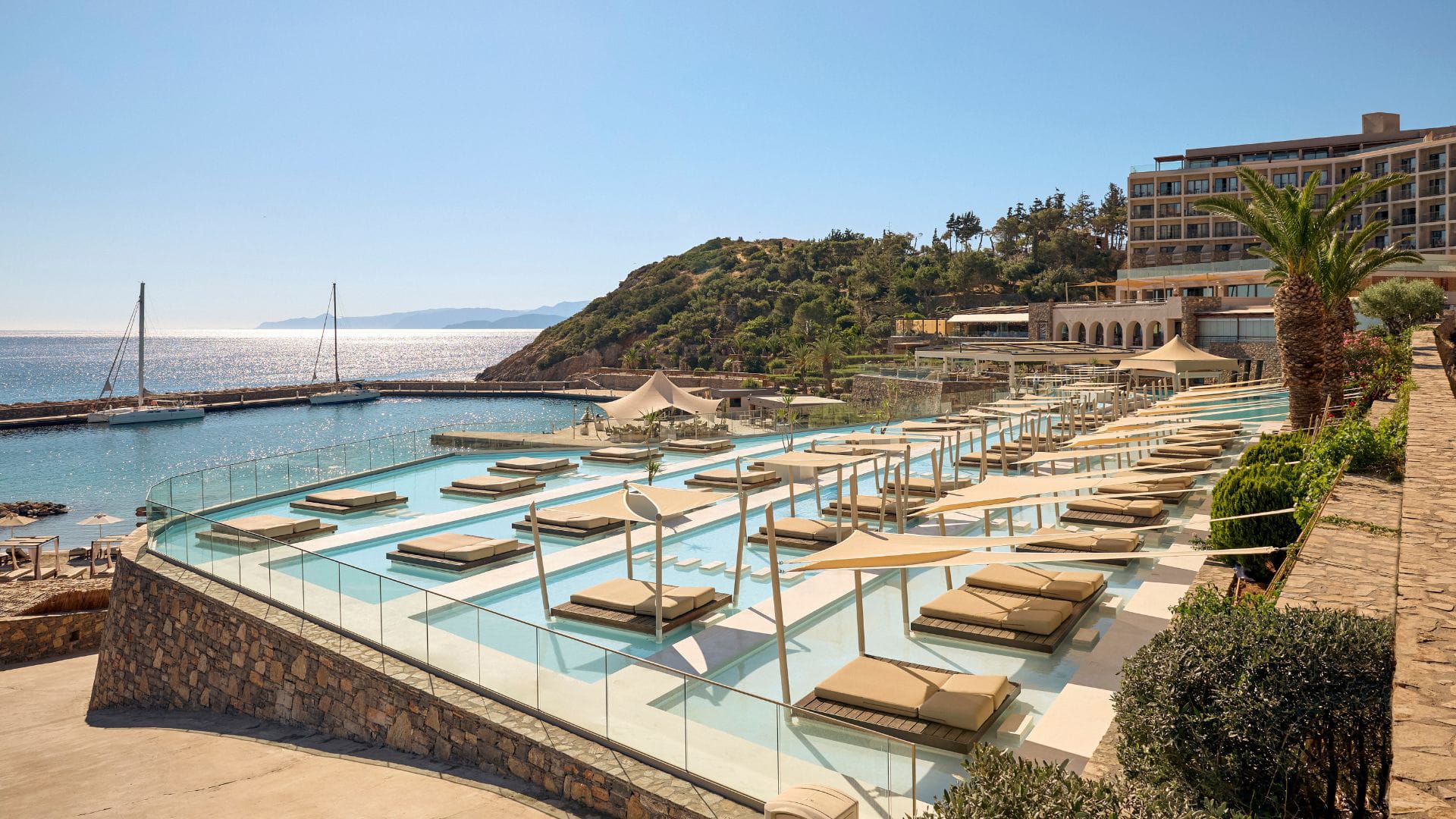 a pool with lounge chairs and umbrellas