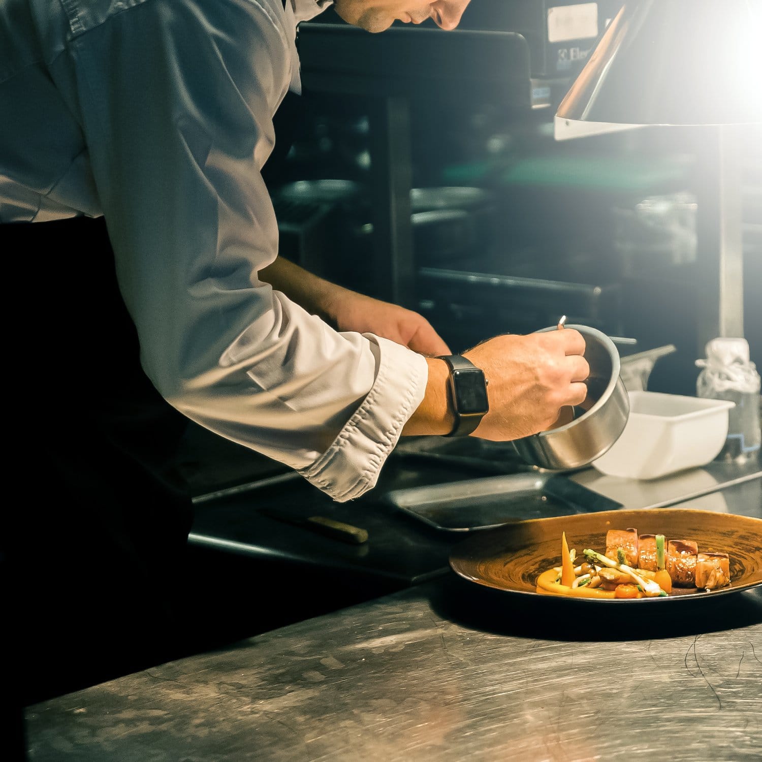 a person cooking food in a kitchen