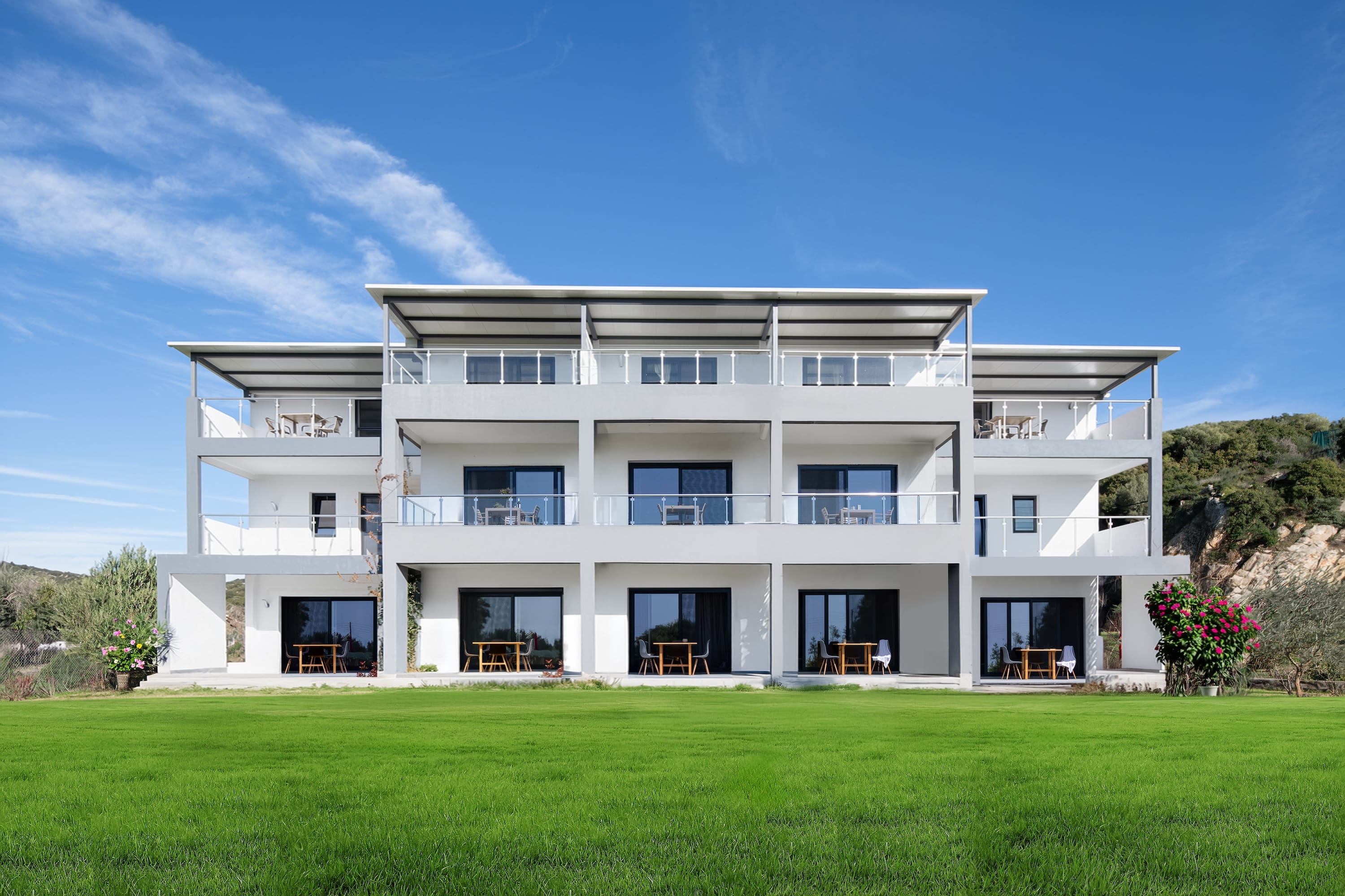 a white house with a lawn