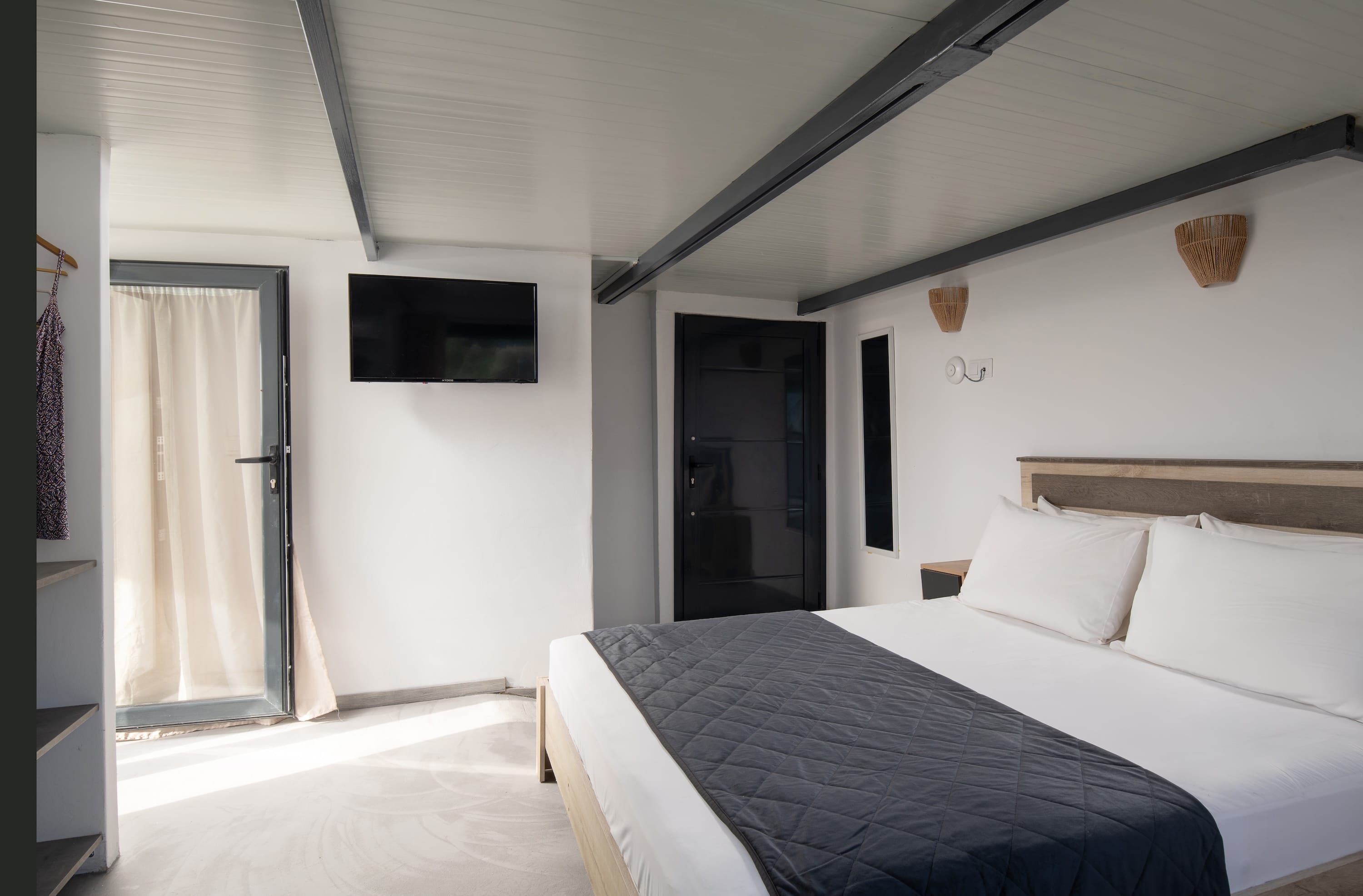 a bedroom with a bed and a tv