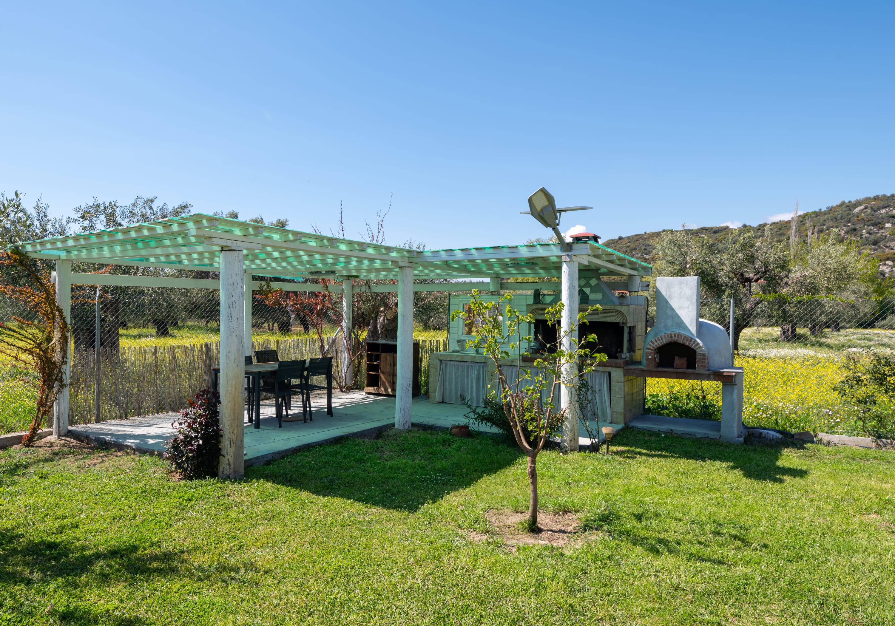a covered patio with a table and chairs