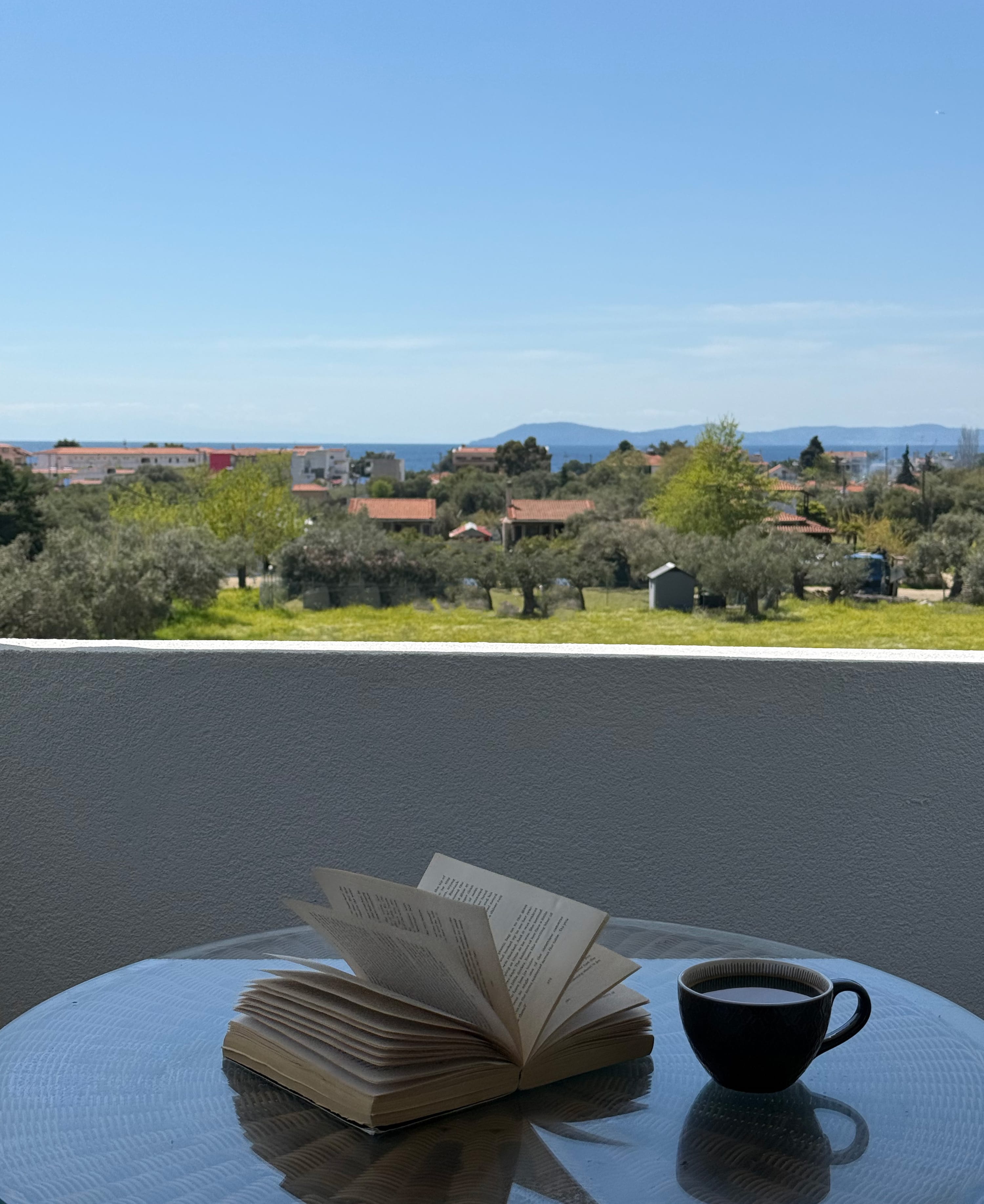 a book and a cup of coffee on a table