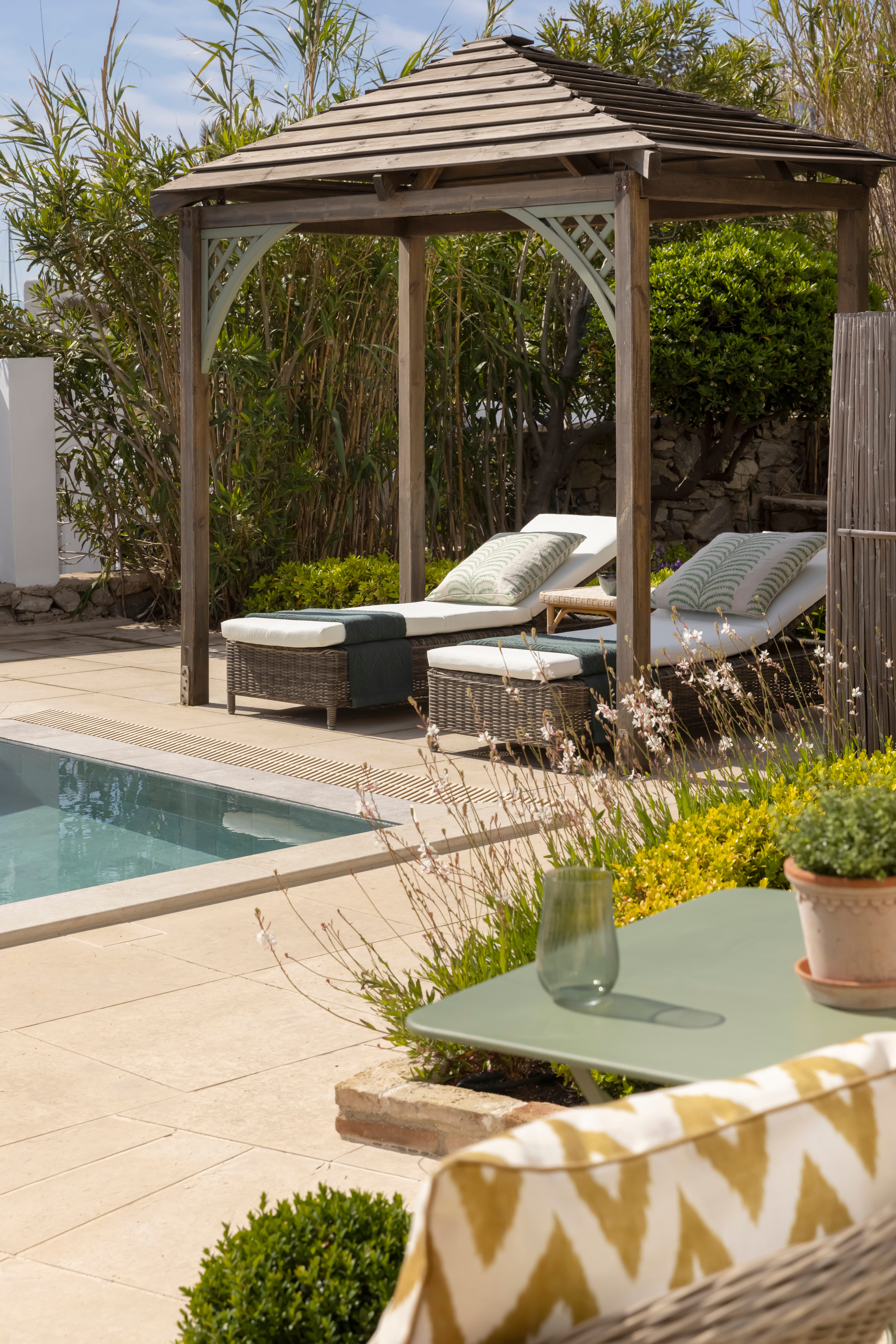 a patio with a pool and a gazebo