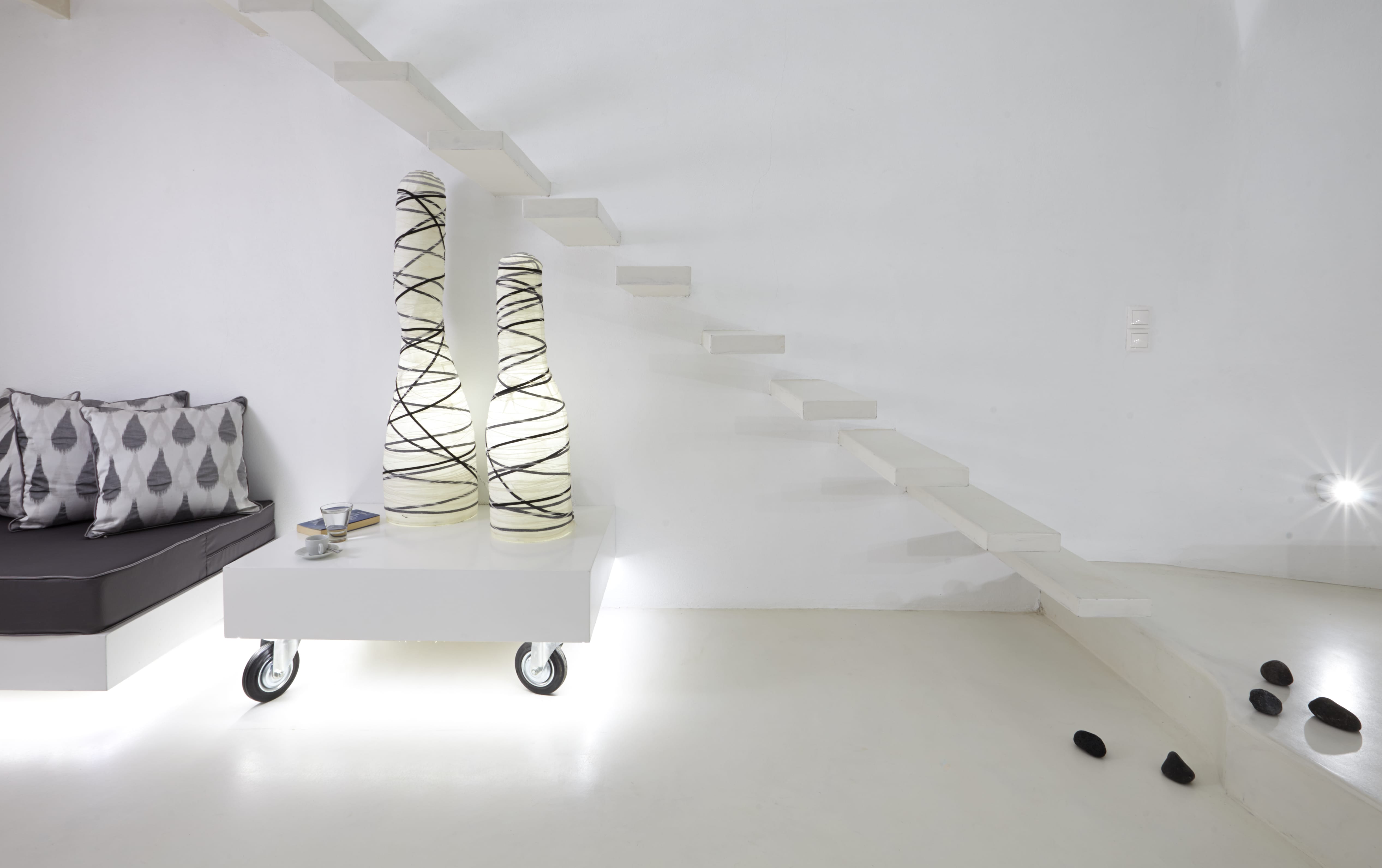 a white wall with a white wall and a couch and a table