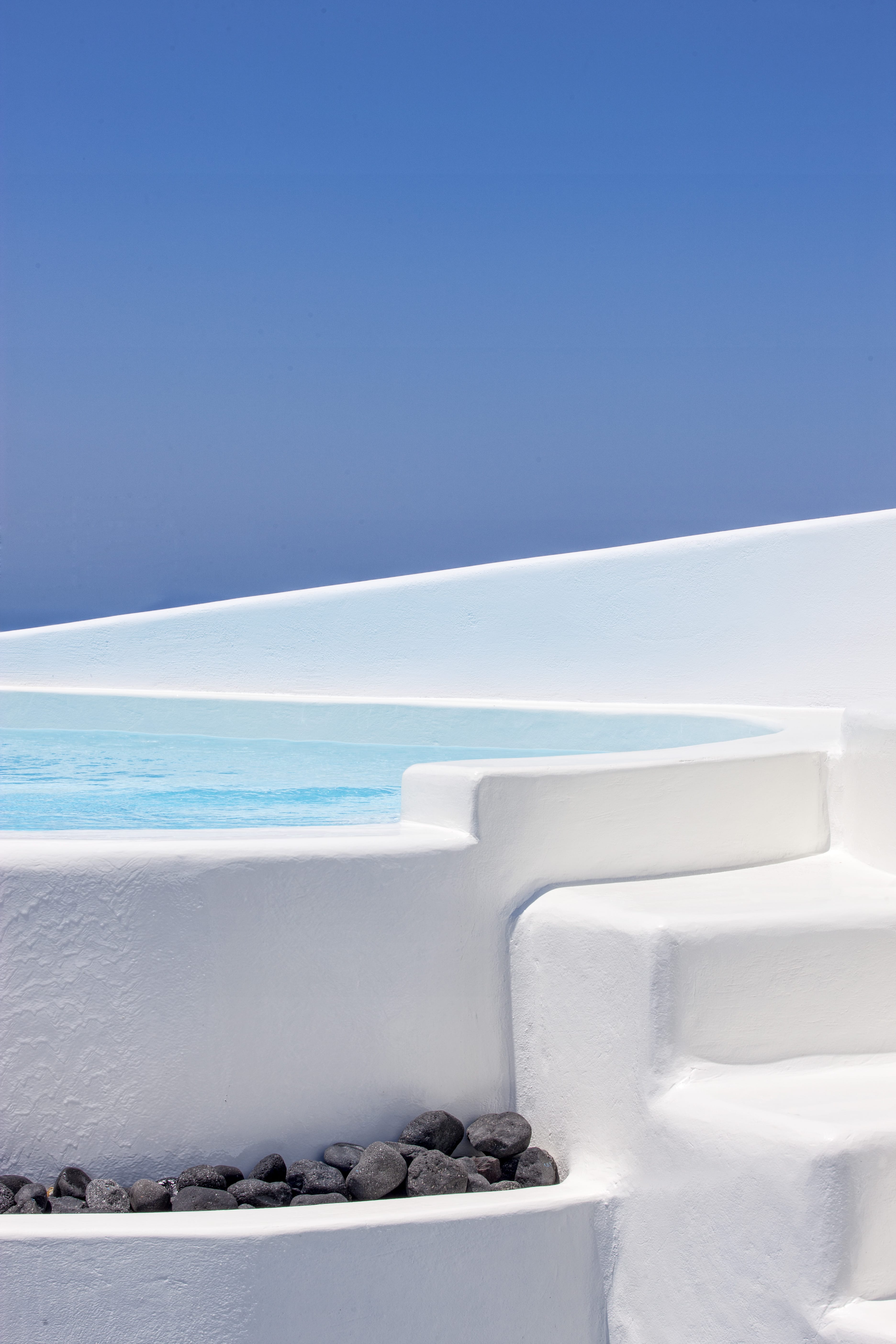 a white staircase leading to a pool