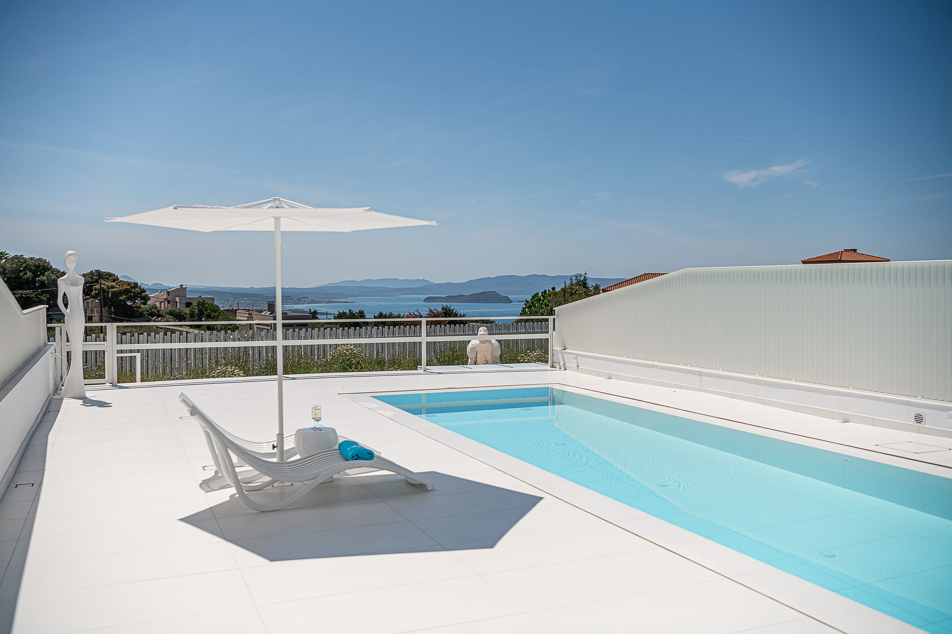 a pool with a deck chair and umbrella