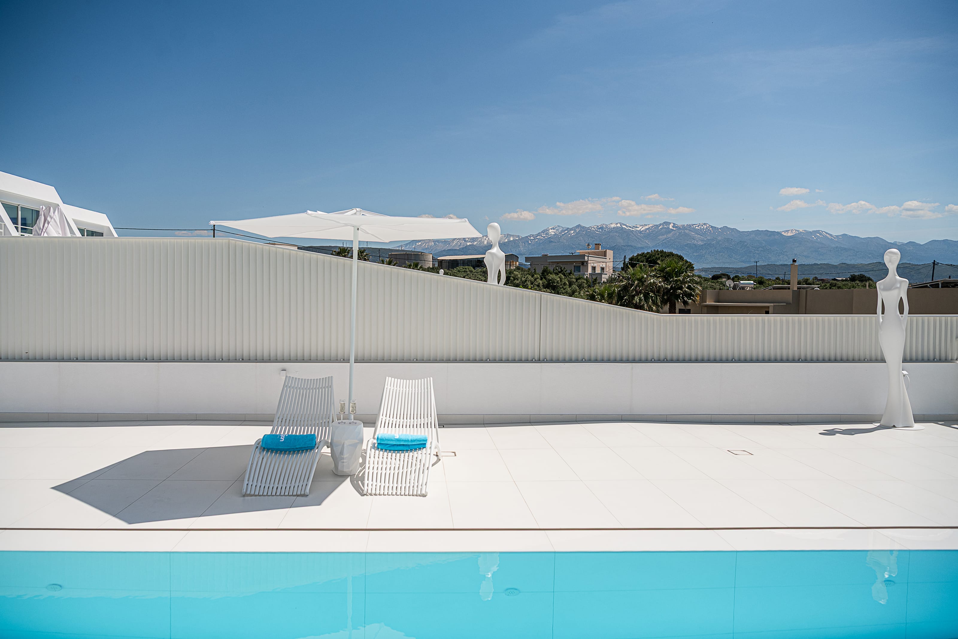 a pool with chairs and umbrella