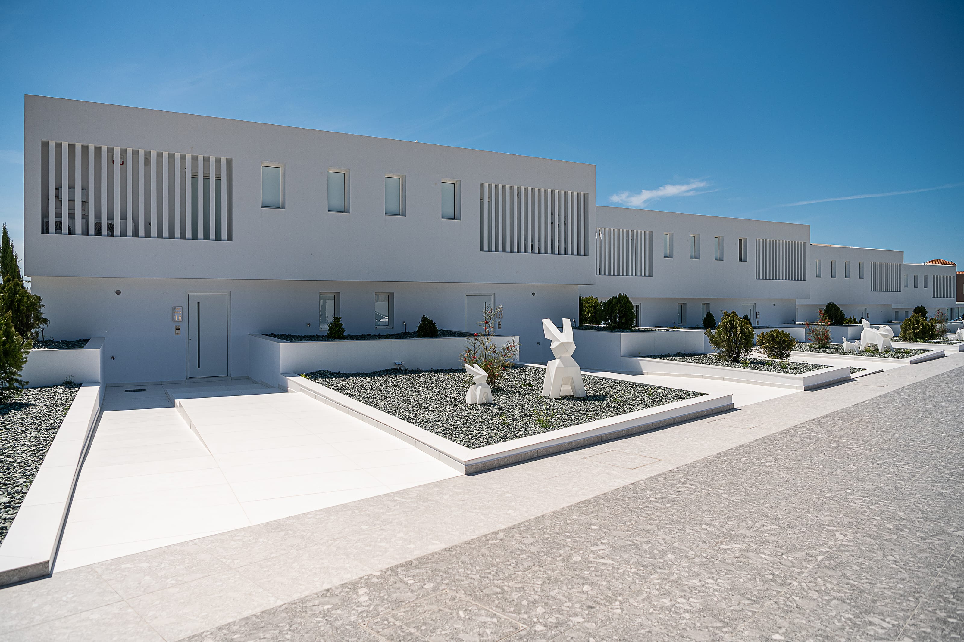 a white building with a garden