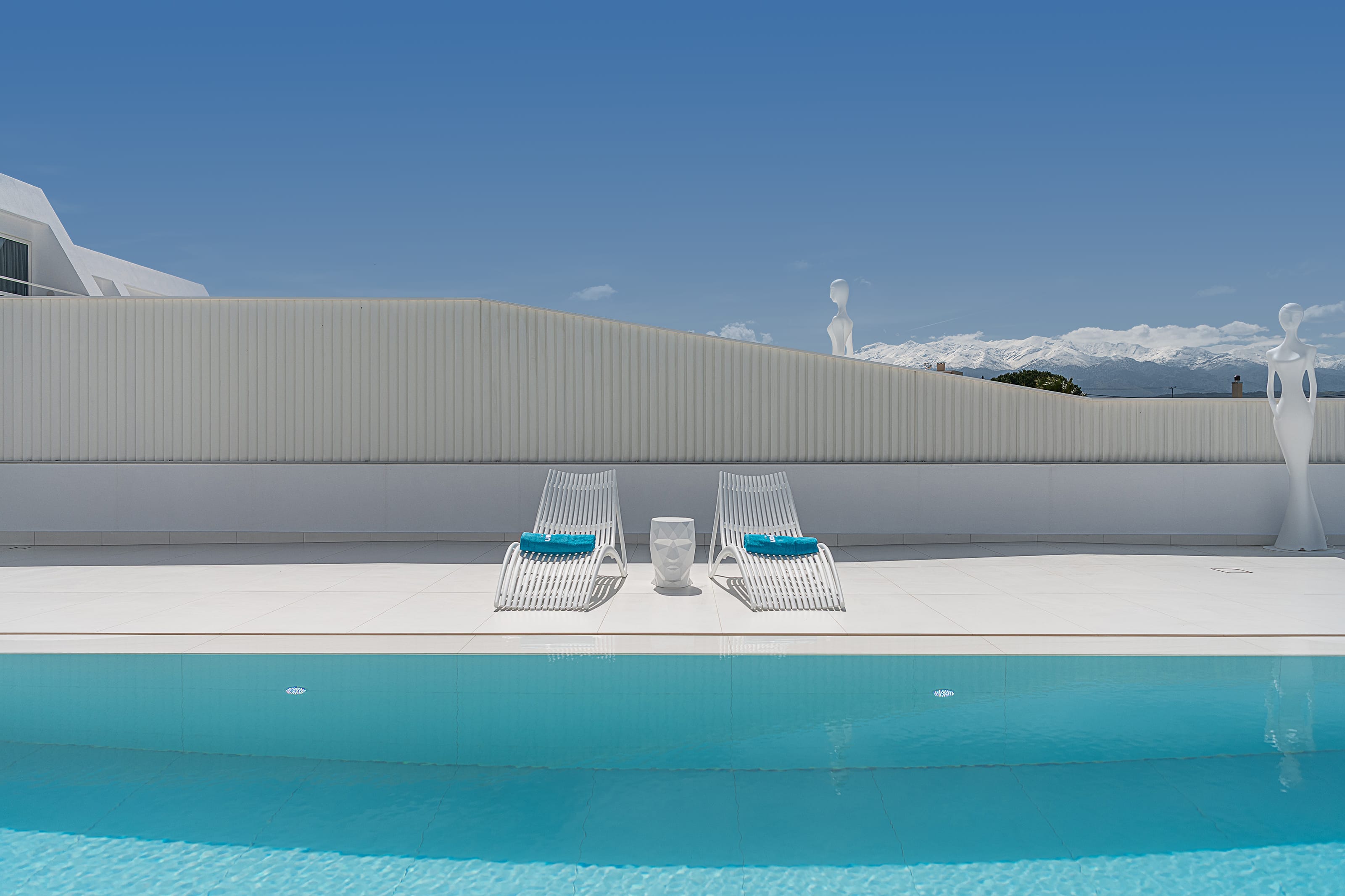 chairs on a deck by a pool