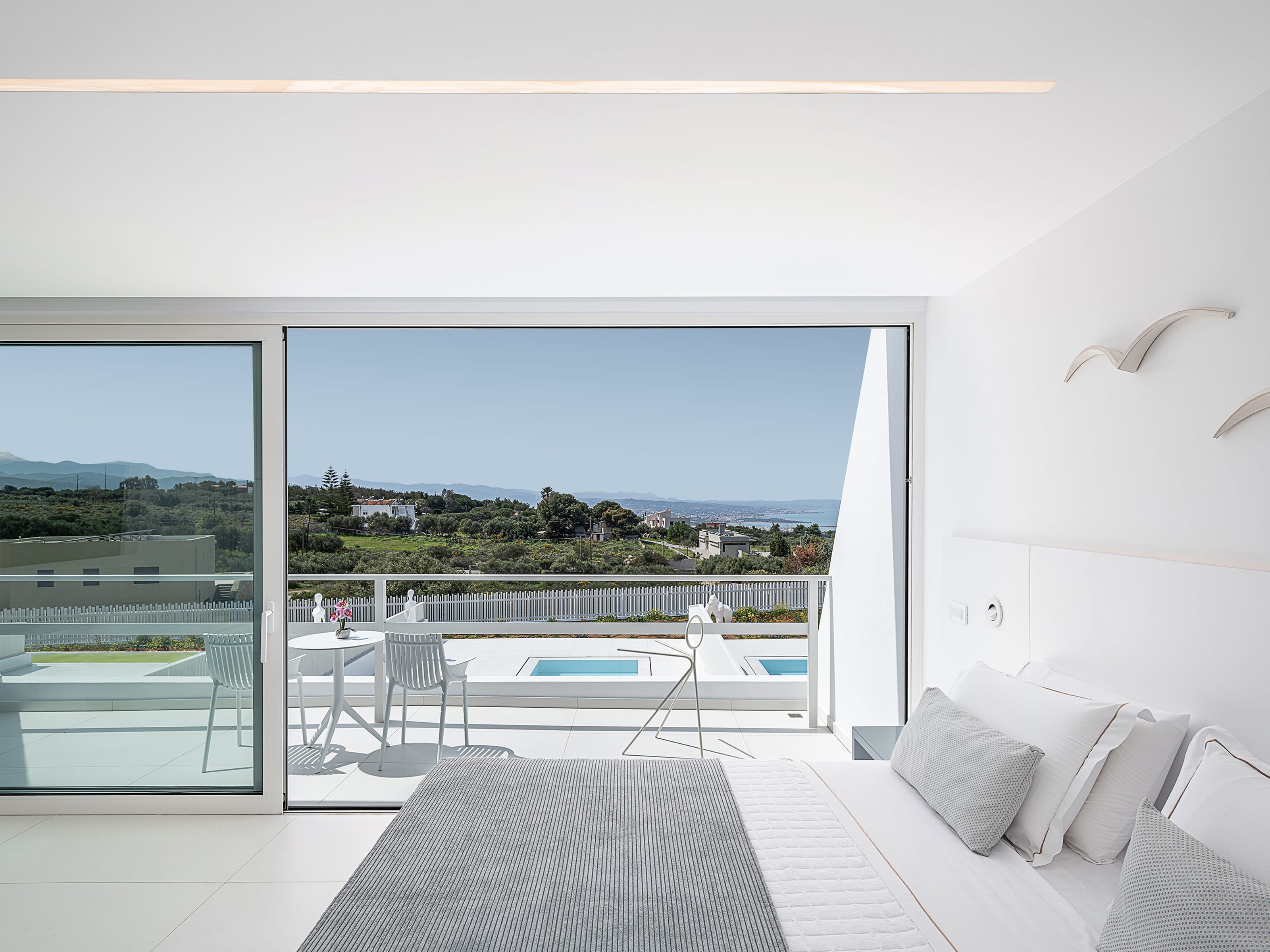 a room with a pool and a table and chairs