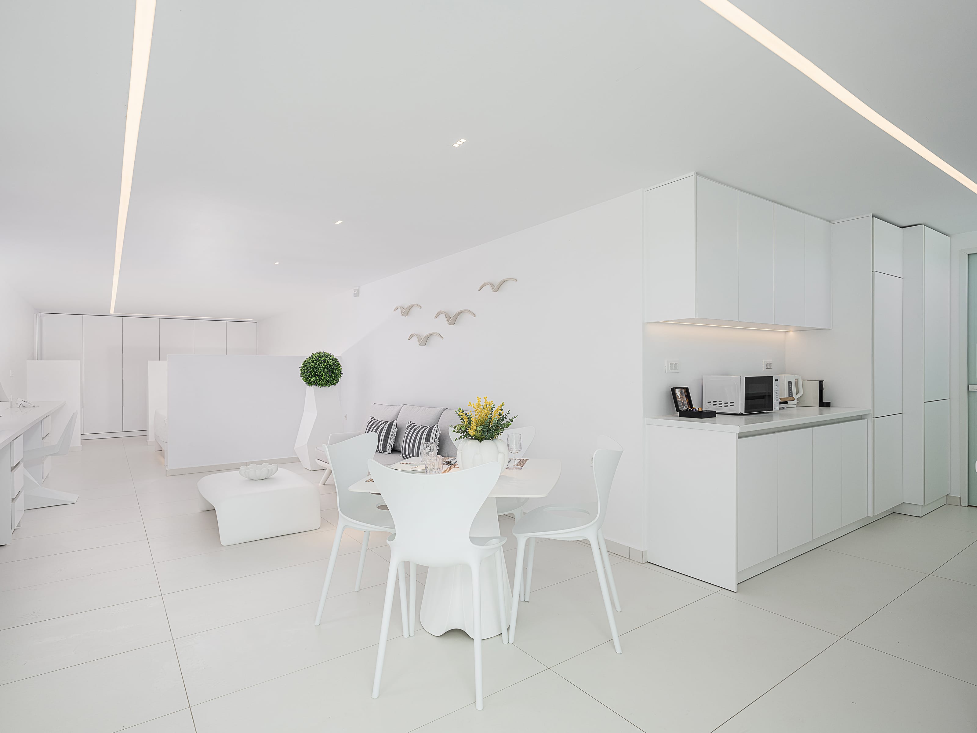 a white room with a table and chairs