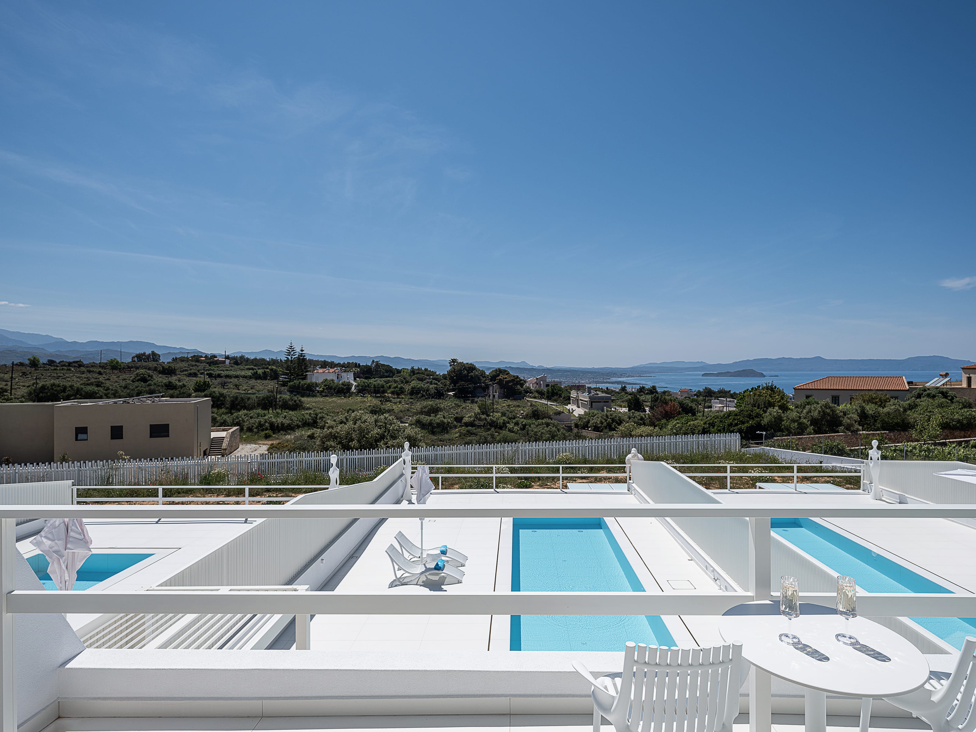 a rooftop with a view of the ocean and trees