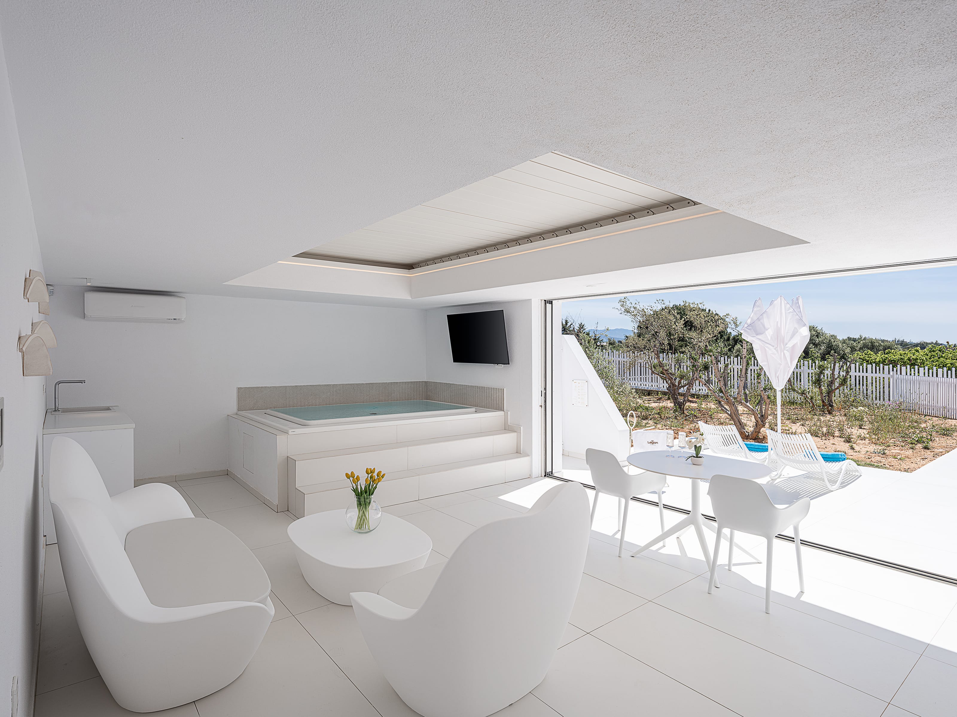 a white room with a white table and chairs