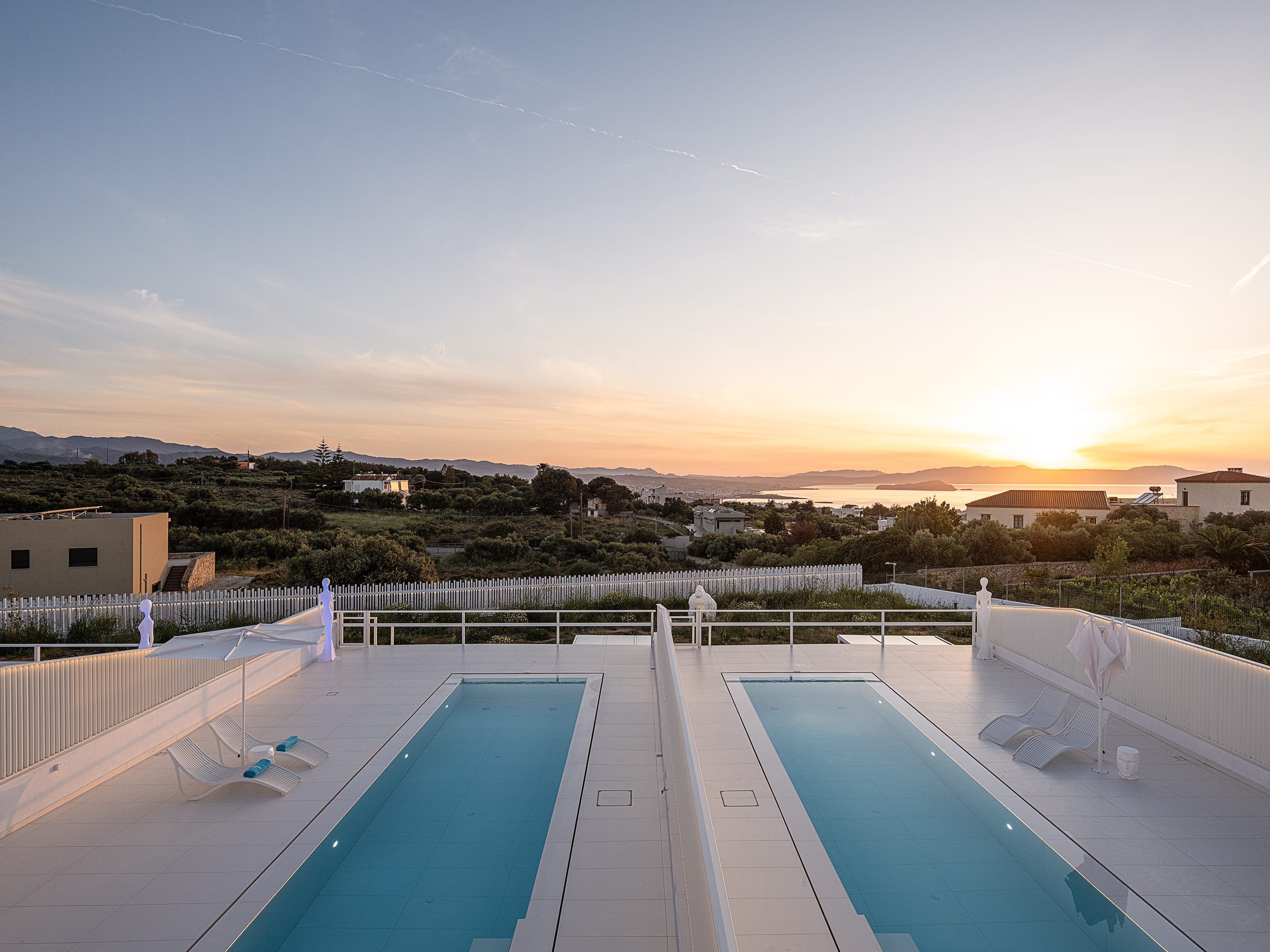 a pool with a deck and chairs on top of it