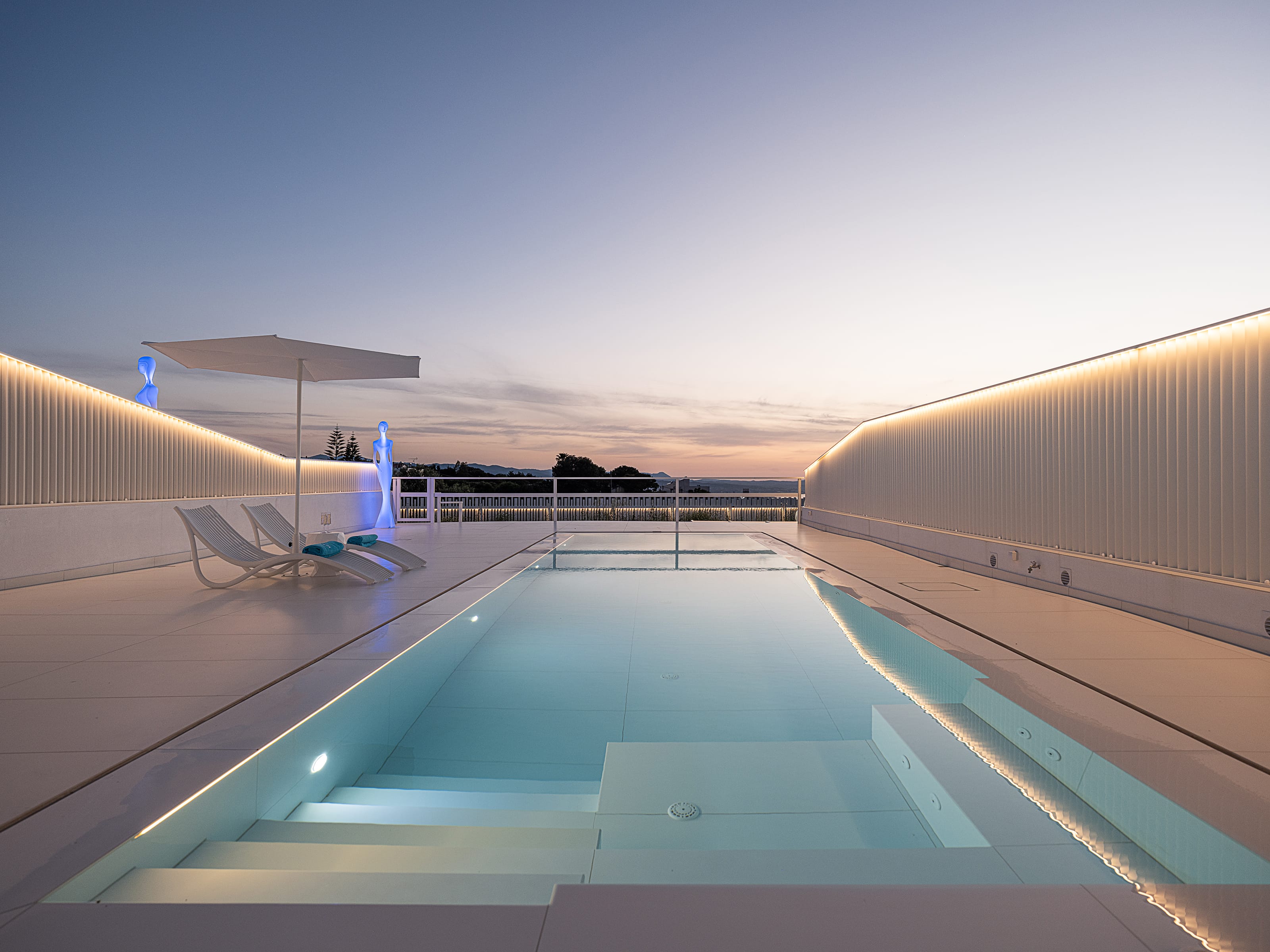 a pool with a deck and chairs