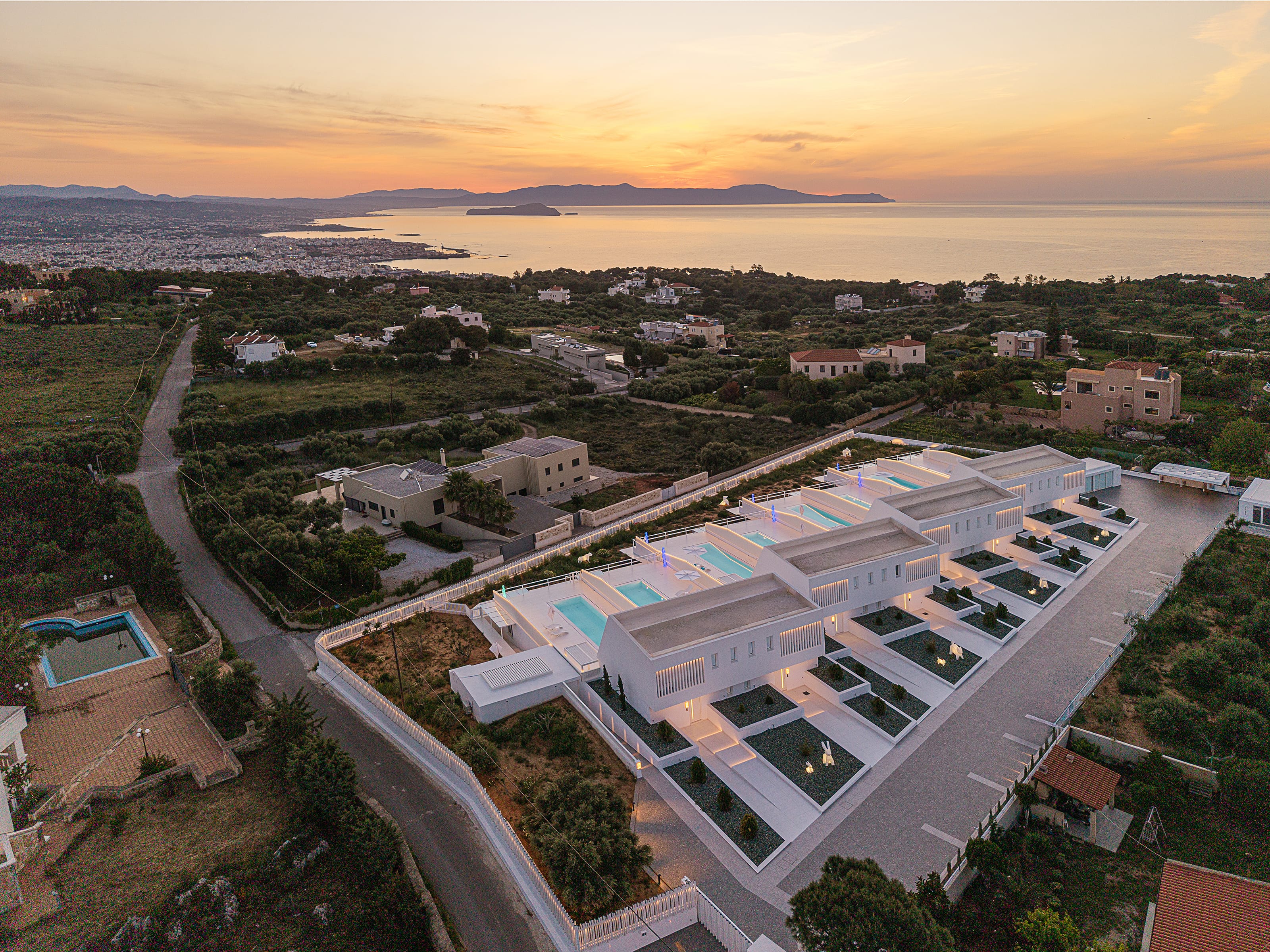 a large building with a pool in the middle of a road