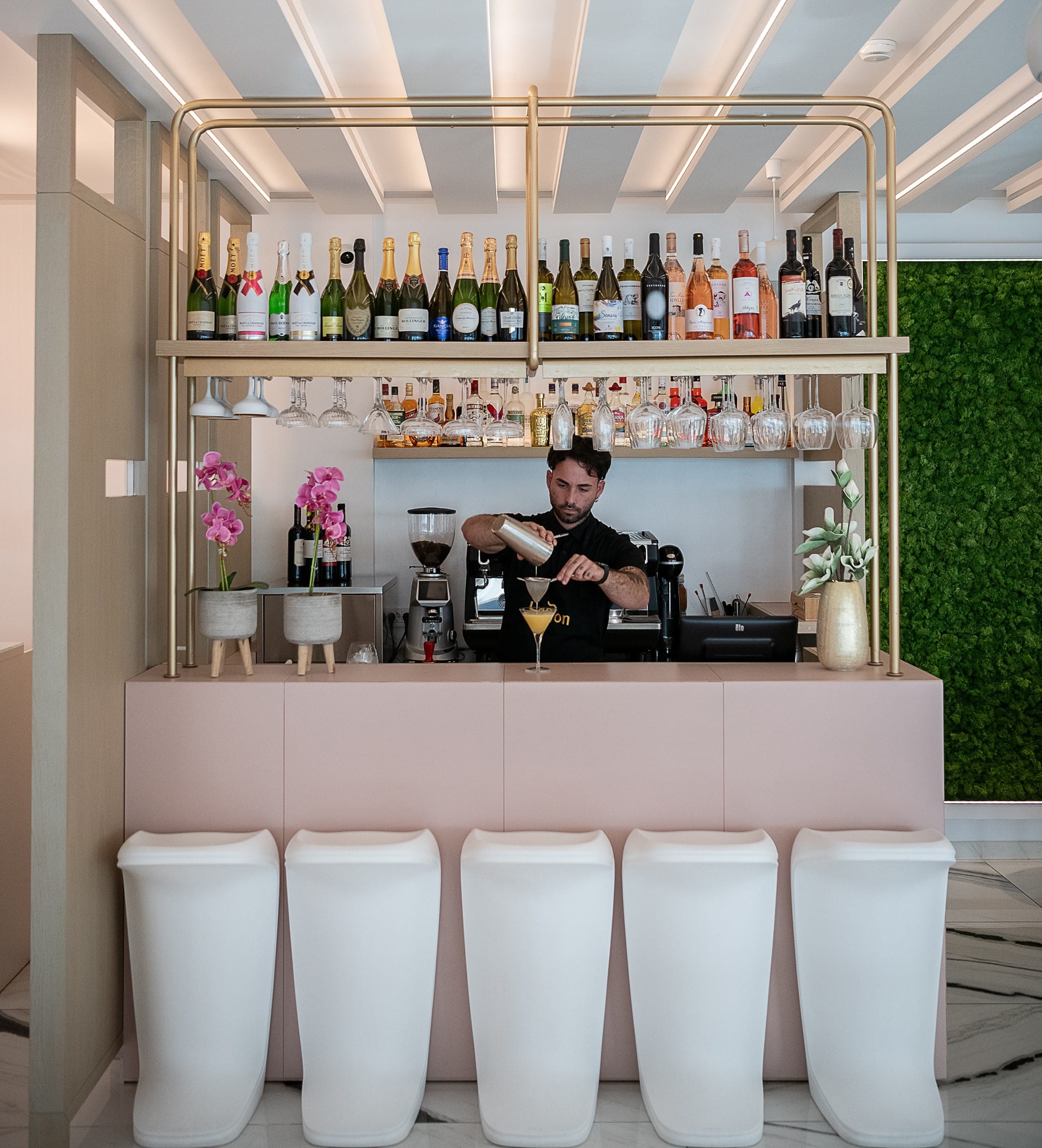 a person behind a counter with a bar behind him
