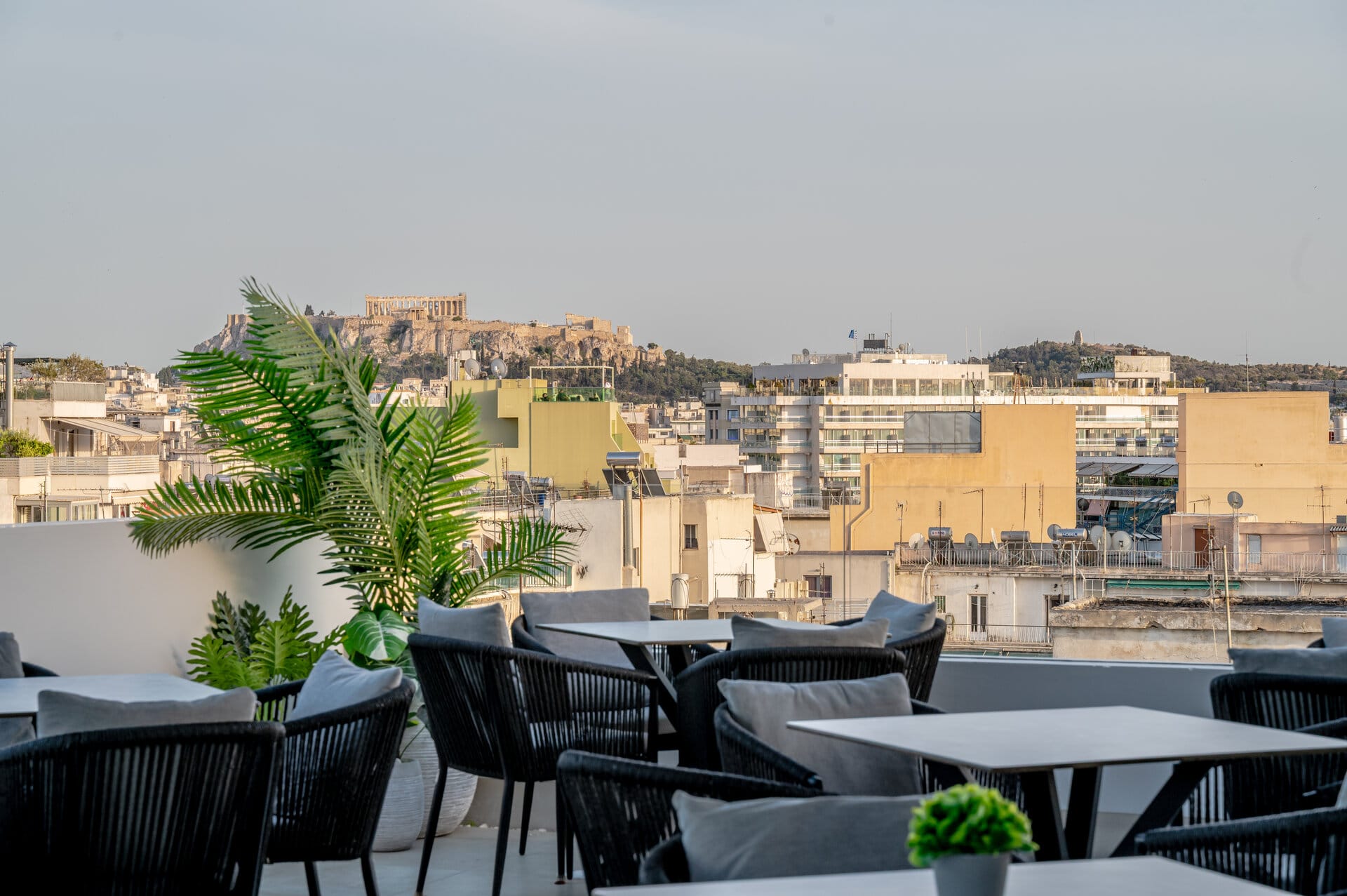 a group of tables and chairs with a view of a city